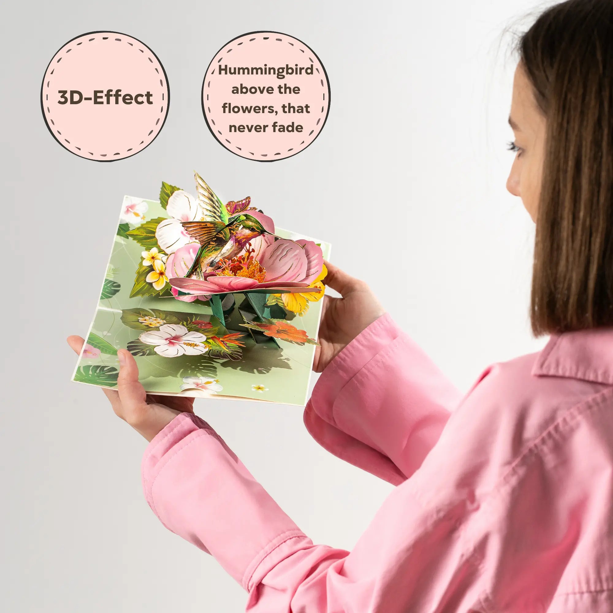Woman holding a floral card with a Hummingbird and a  3D effect