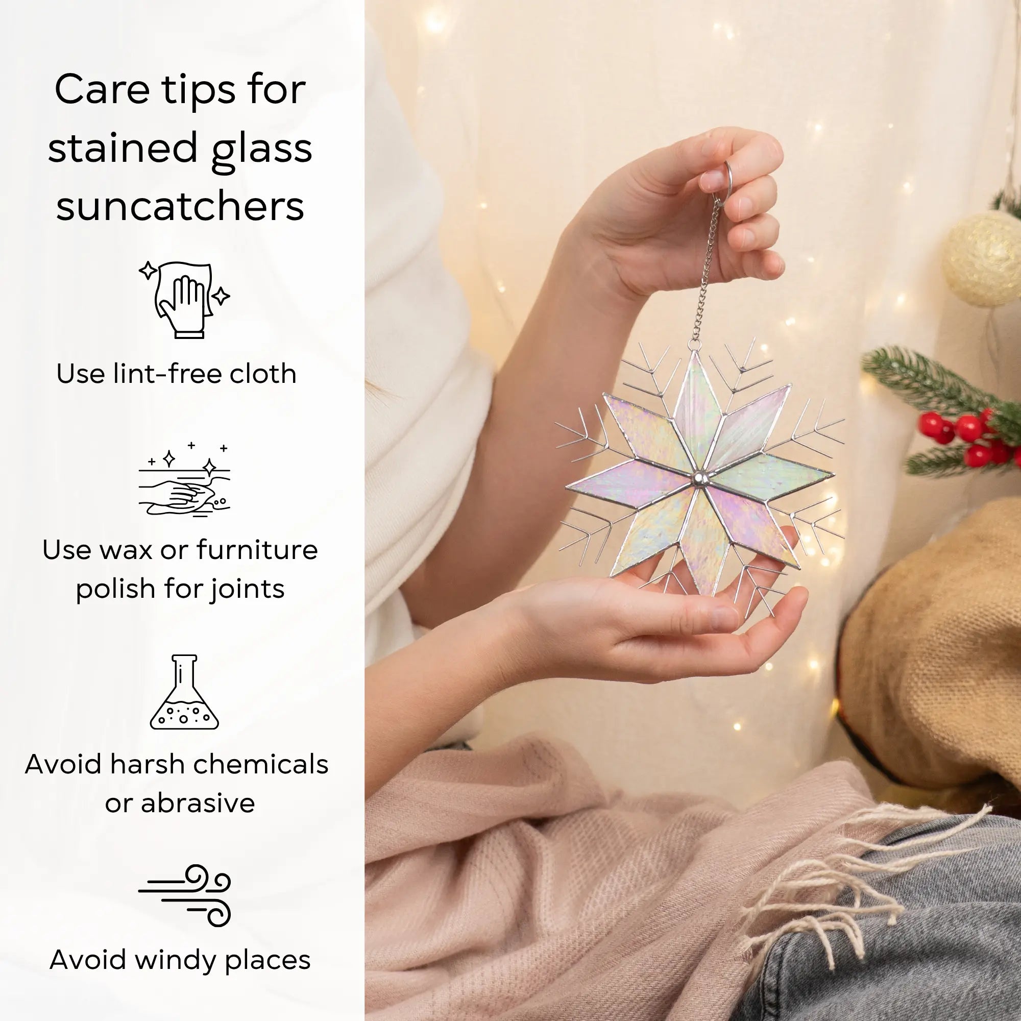 Hands holding a stained glass snowflake suncatcher with care tips on the left side: use lint-free cloth, polish joints with car wax or furniture polish, avoid harsh chemicals, and windy places.