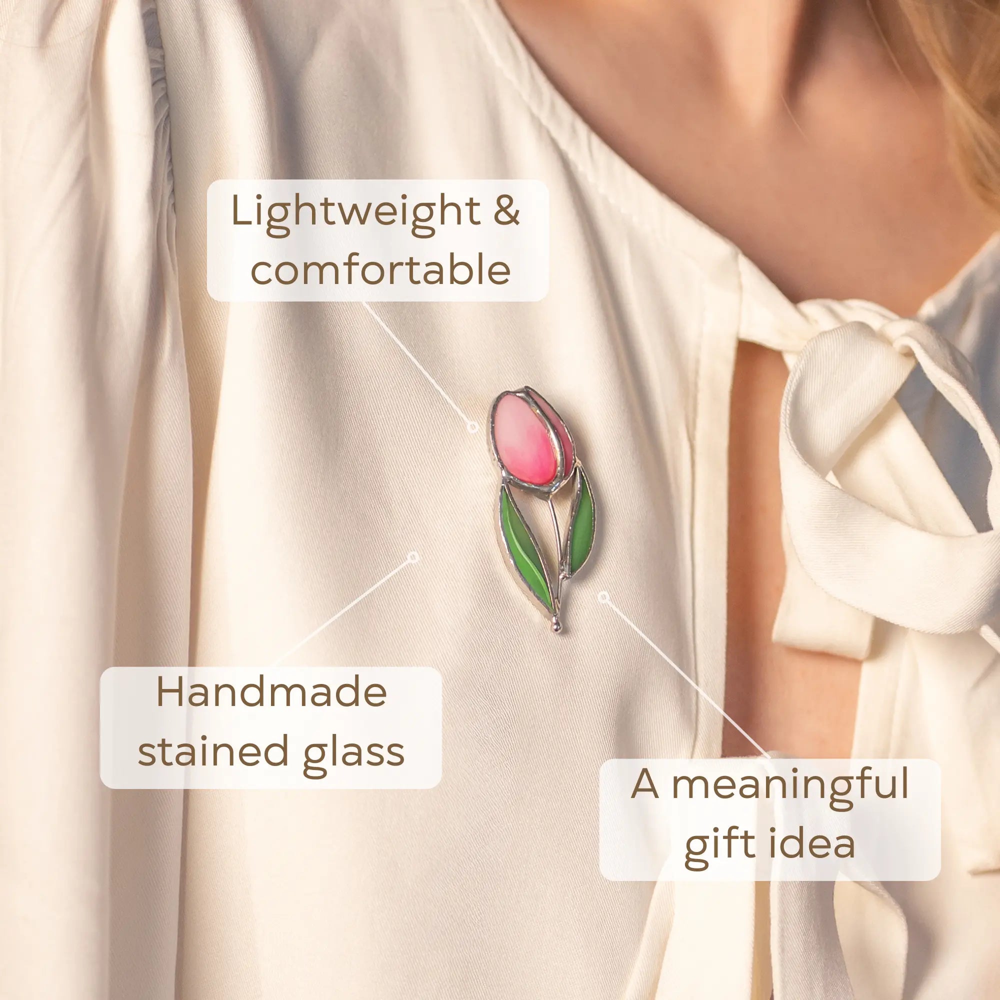 Pink tulip stained glass brooch on a white blouse as a meaningful gifts idea for loved ones
