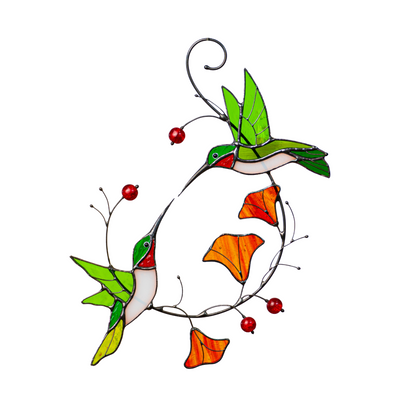 Stained glass hummingbird in green, red, and white flying toward an orange flower