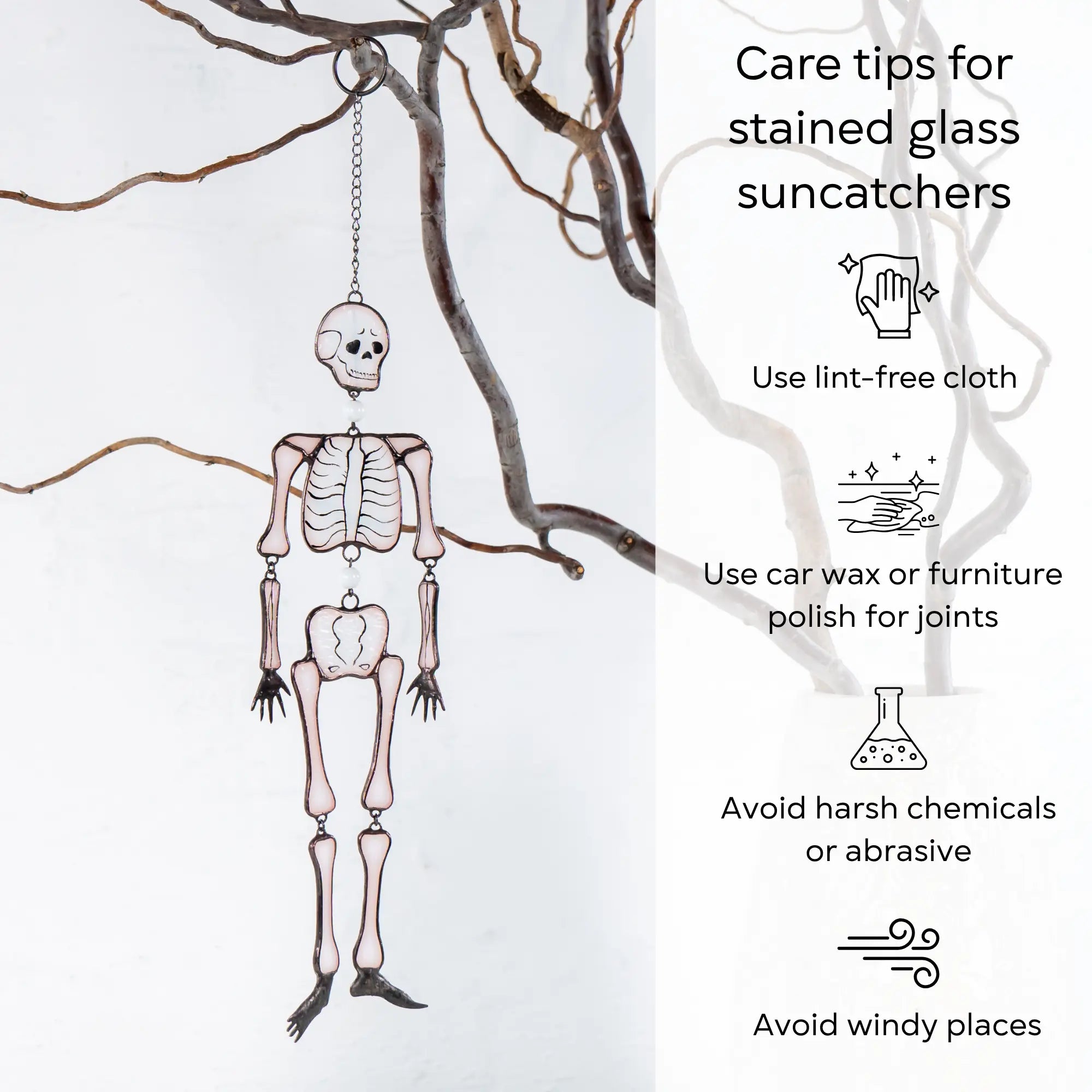 Glass skeleton suncatcher hanging on branch with listed care tips including cloth, polish, and chemical warnings