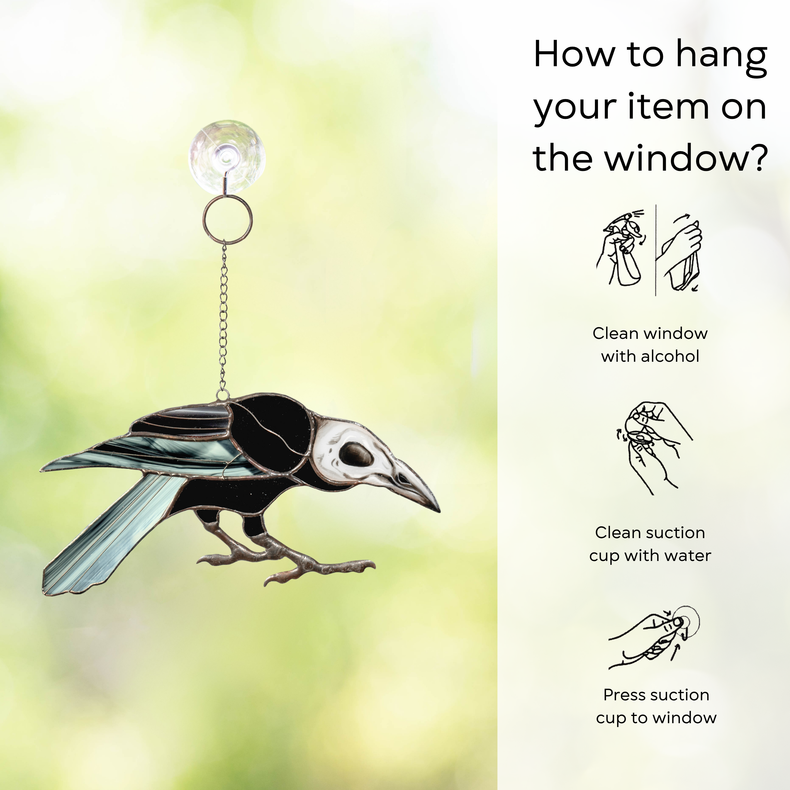 Stained glass raven with skull face hanging by a chain on a window, shown beside hanging instructions: clean window and suction cup, press a cup to the surface