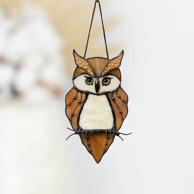 Stained glass owl ornament with detailed wings and warm hues.