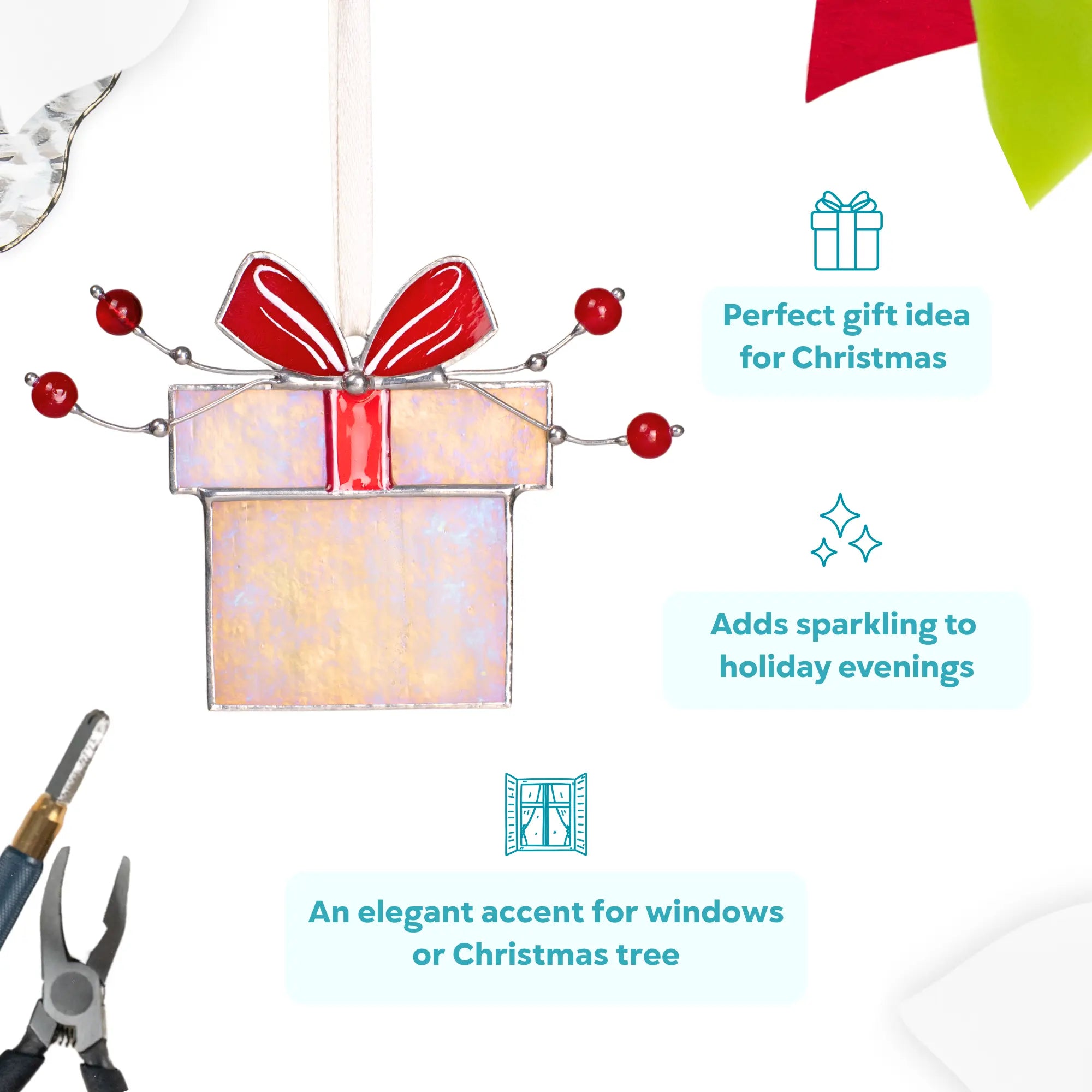 Stained glass gift box ornament with a red bow, decorated with red berries, perfect as a Christmas decor.