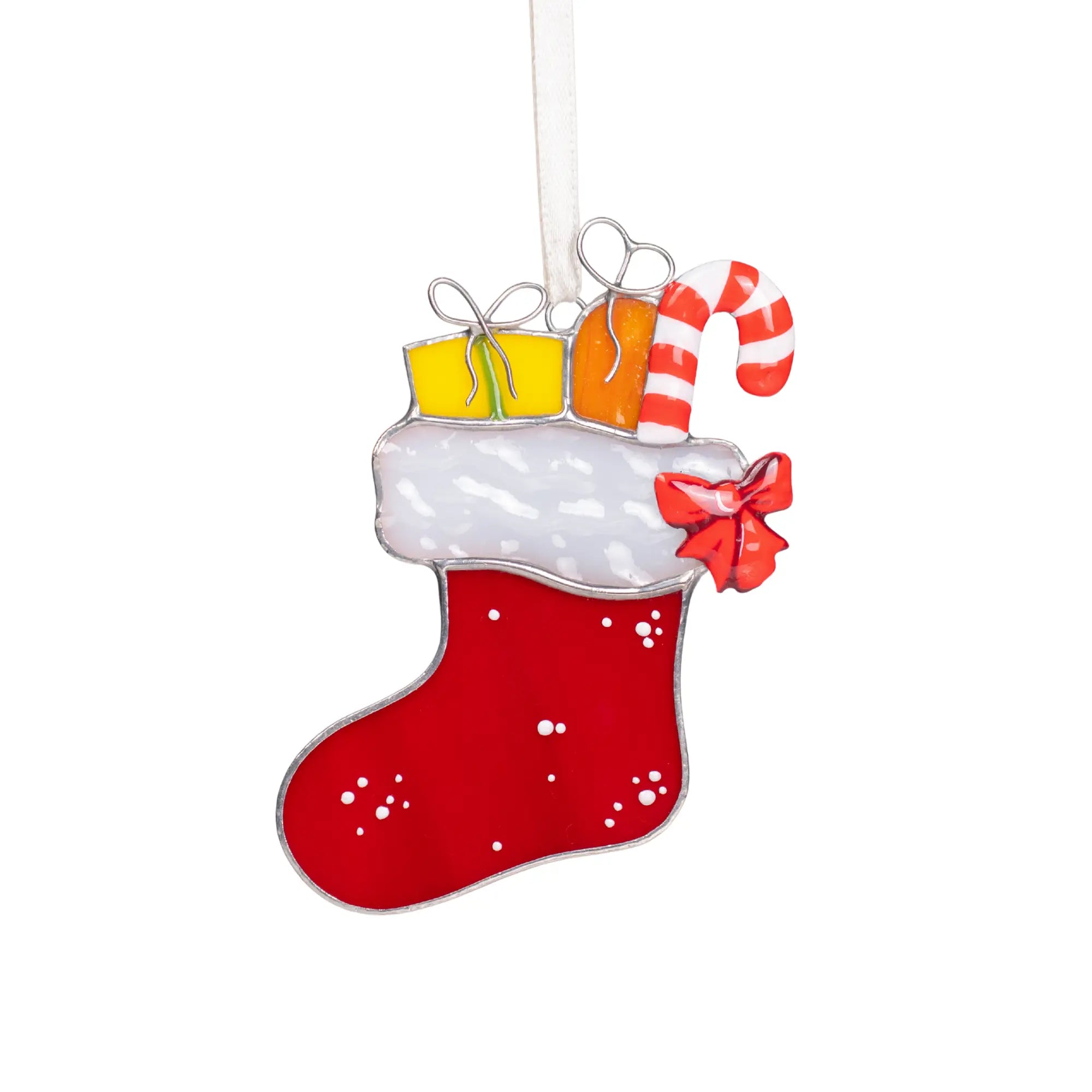 Red stained glass Christmas stocking with white trim, candy cane, gifts, and a red bow hanging on a ribbon.