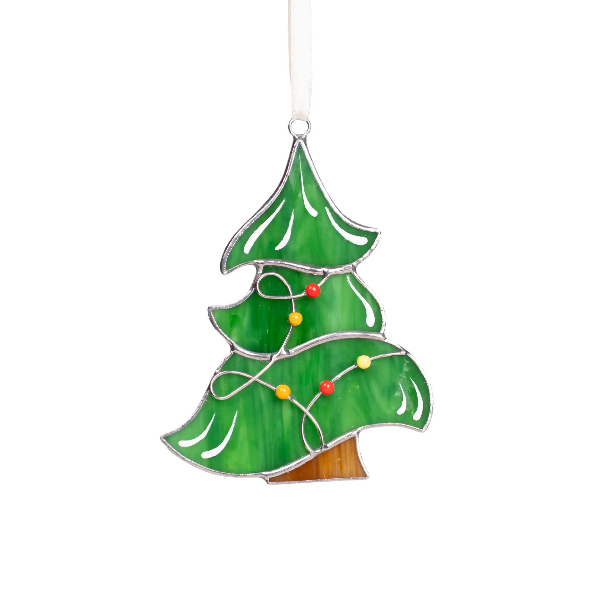 Green stained glass Christmas tree suncatcher with red, yellow, and orange lights in garland, hanging on a white ribbon.