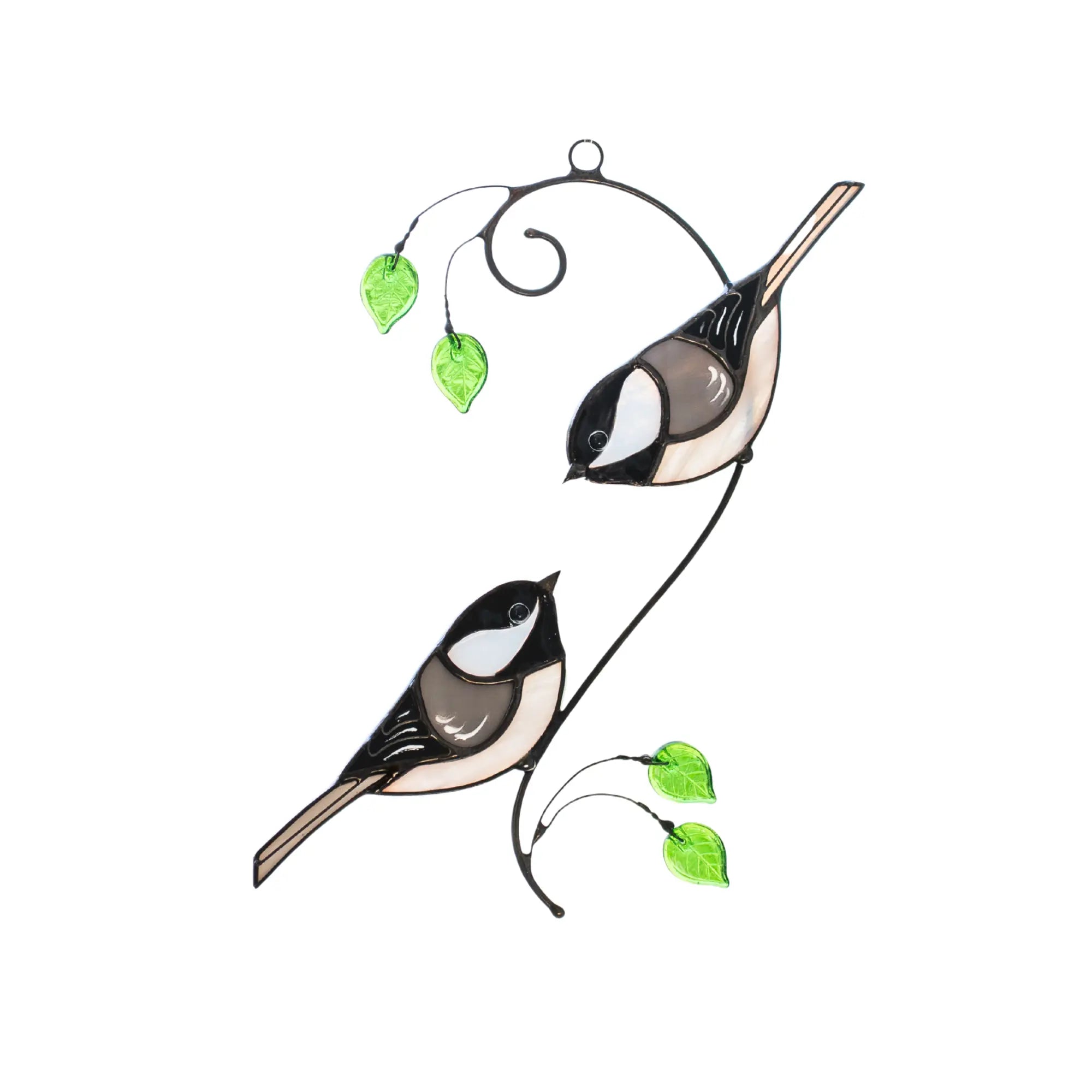Stained glass suncatcher featuring two birds on a branch with green leaves on a white background