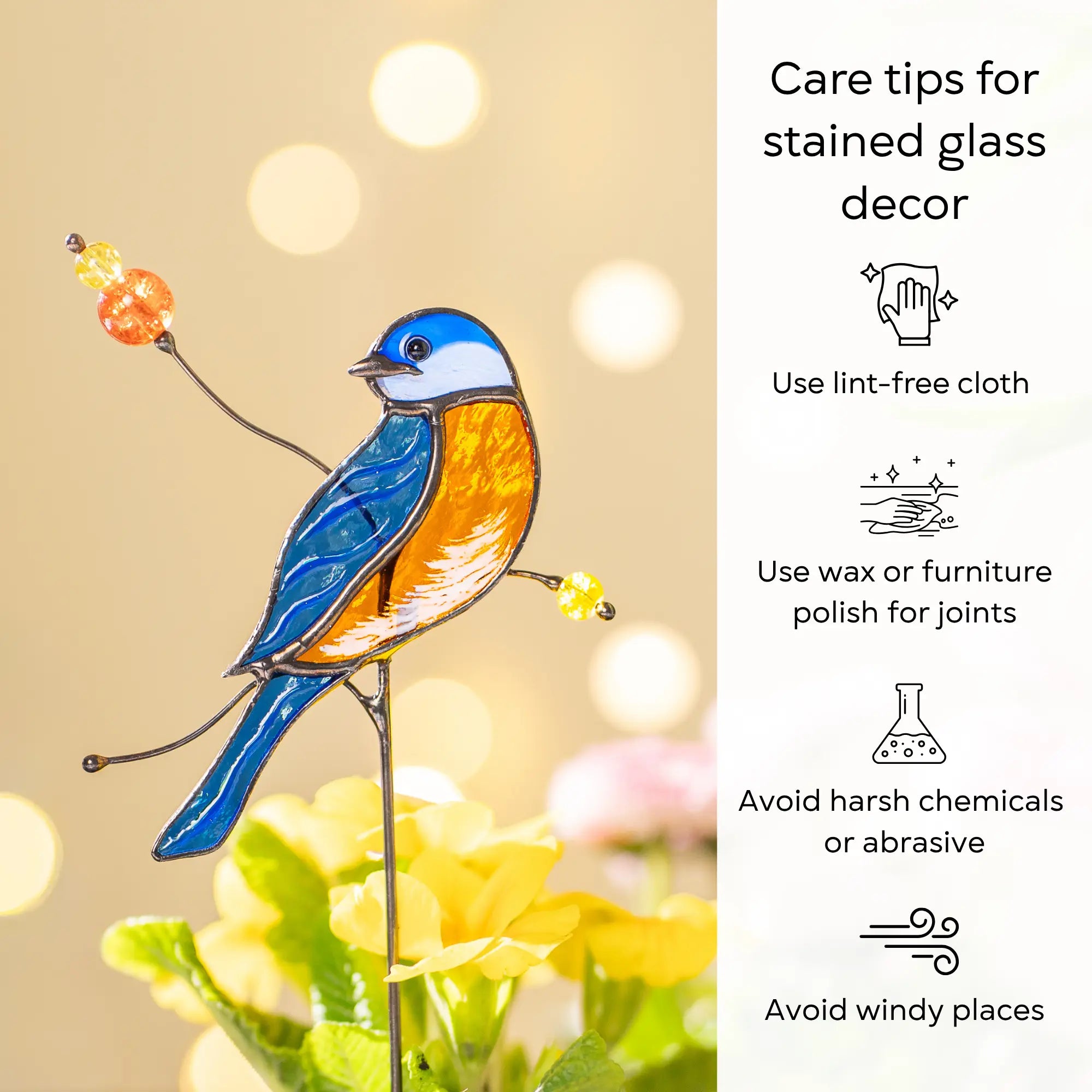 Stained glass bluebird plant stake with care tips on a blurred background: use lint-free cloth, polish joints with car wax or furniture polish, avoid harsh chemicals, and windy places.