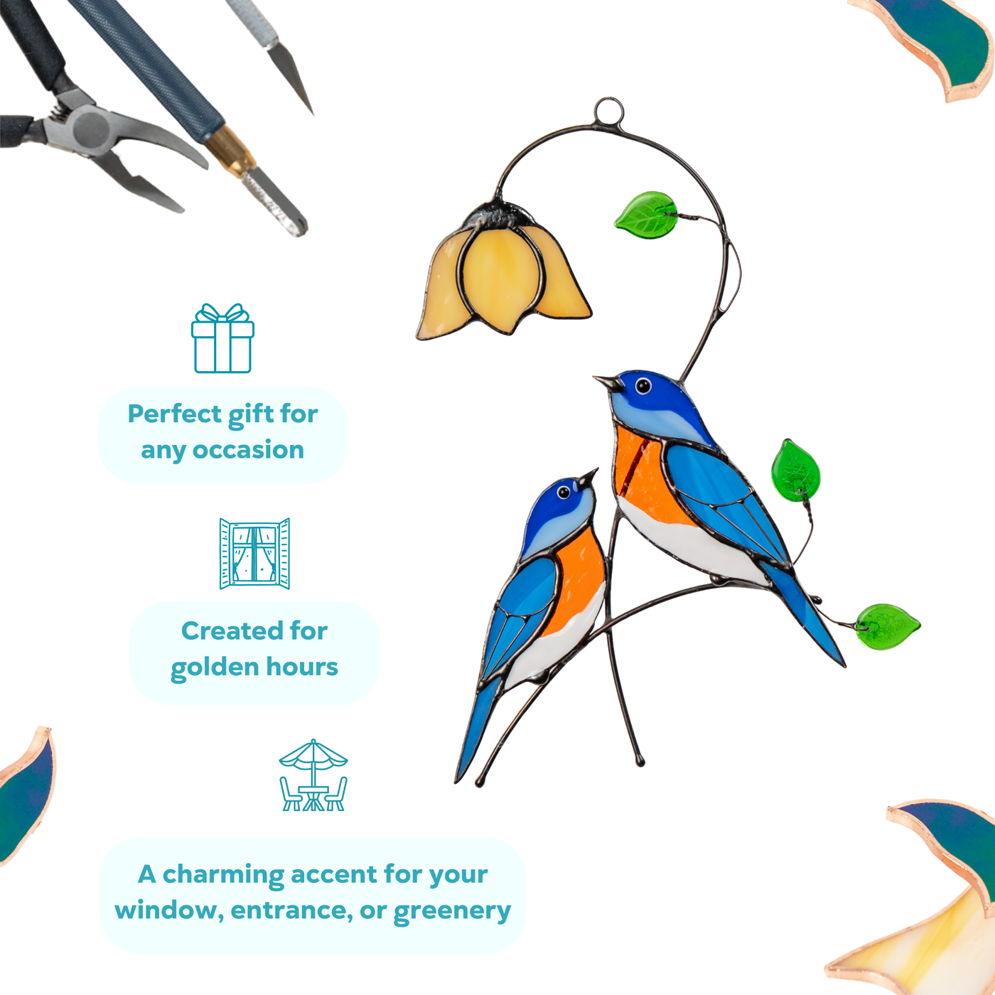 Two stained glass bluebirds under a yellow flower with green leaves.