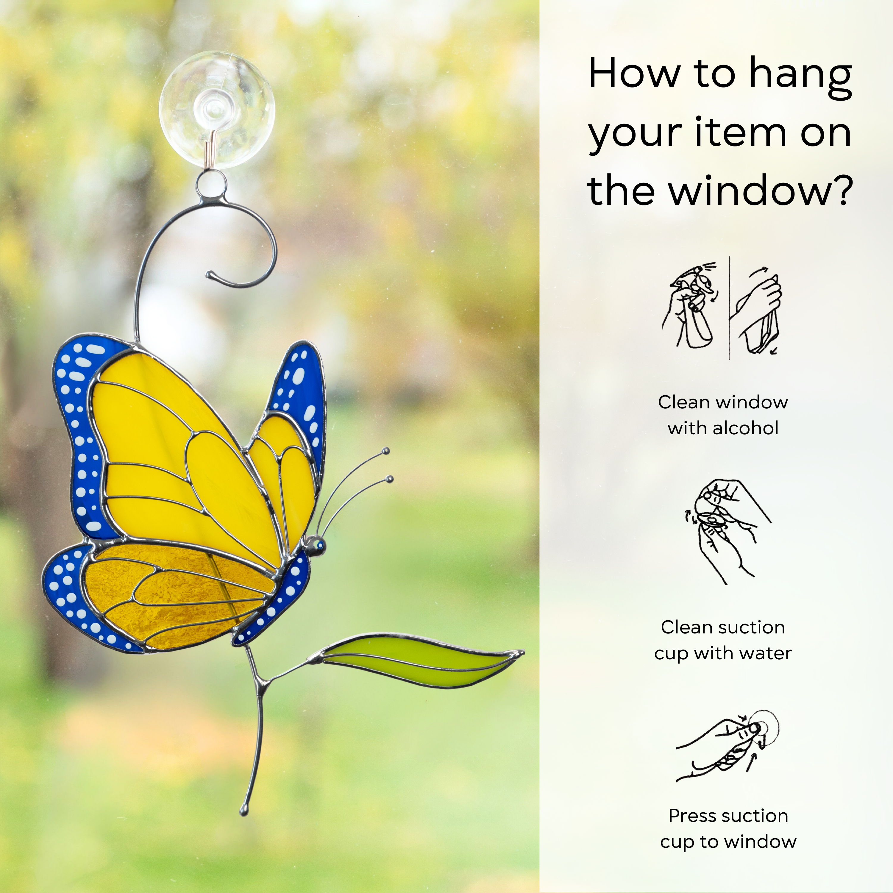 Yellow-blue stained glass butterfly on window with suction cup and illustrated hanging instructions: clean window and suction cup, press a cup to the surface.