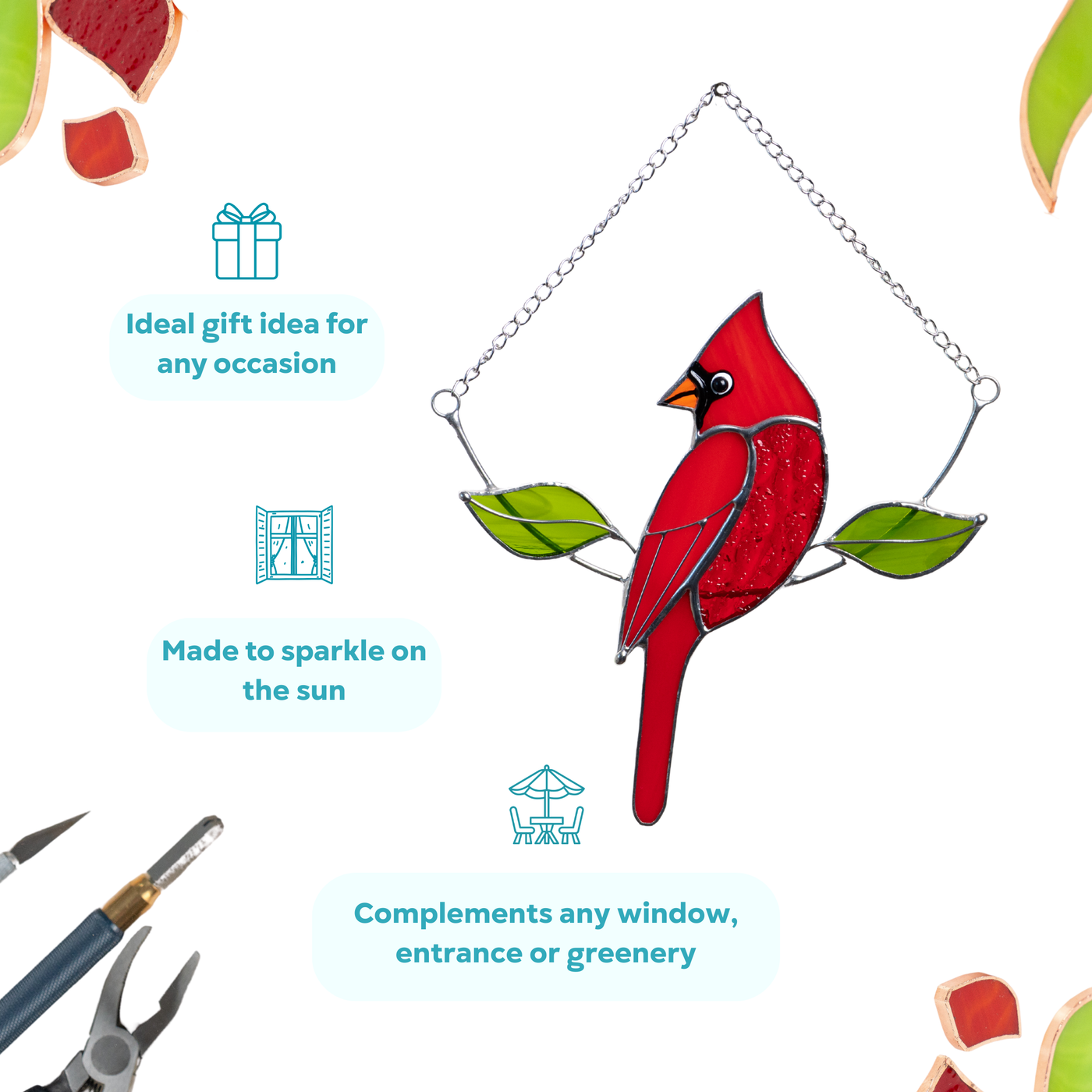 Red stained glass cardinal hanging on a chain, shown with decorative labels and tools. Suncatcher is an ideal gift for any occasion
