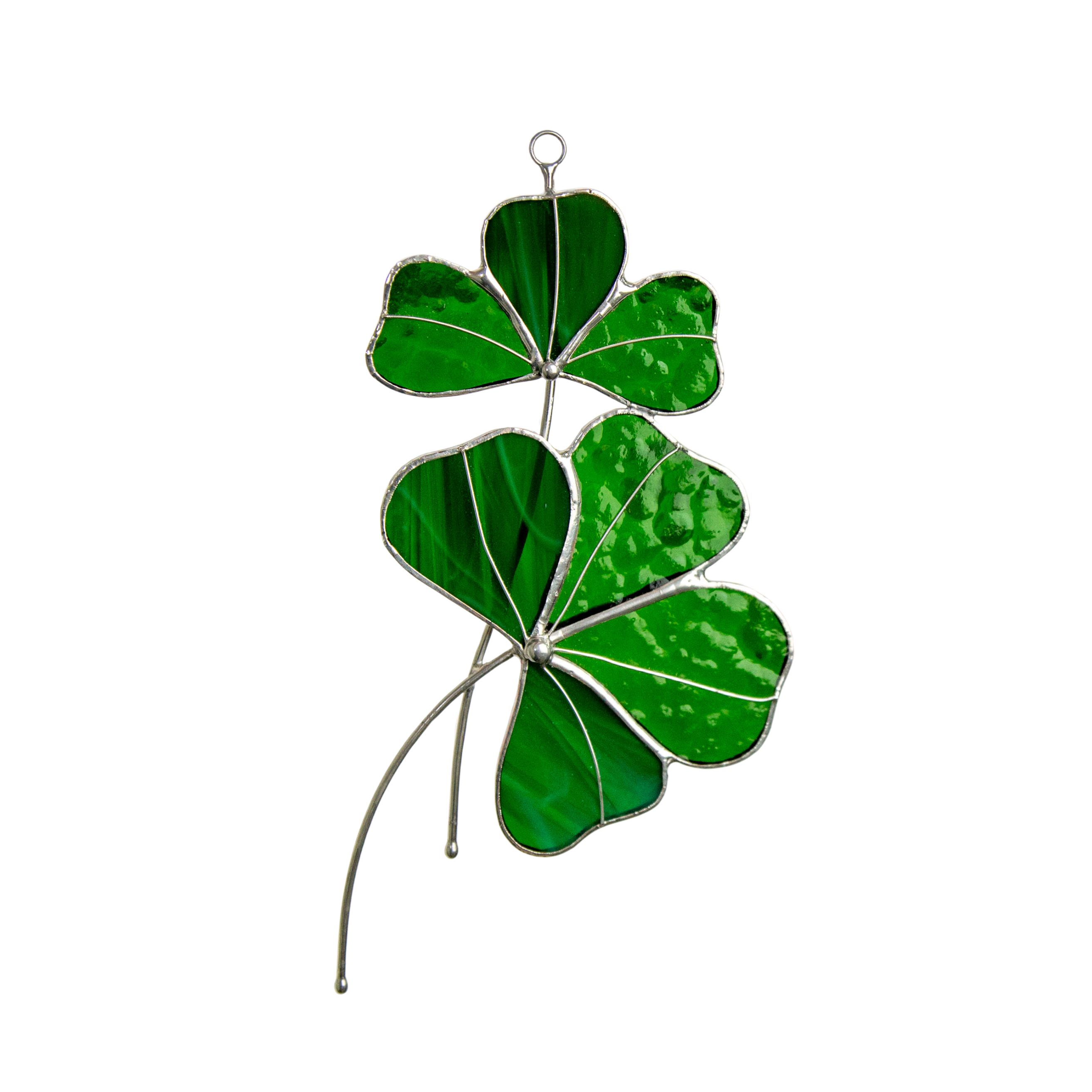 A stained glass clover with two green leaves in different textures, hanging