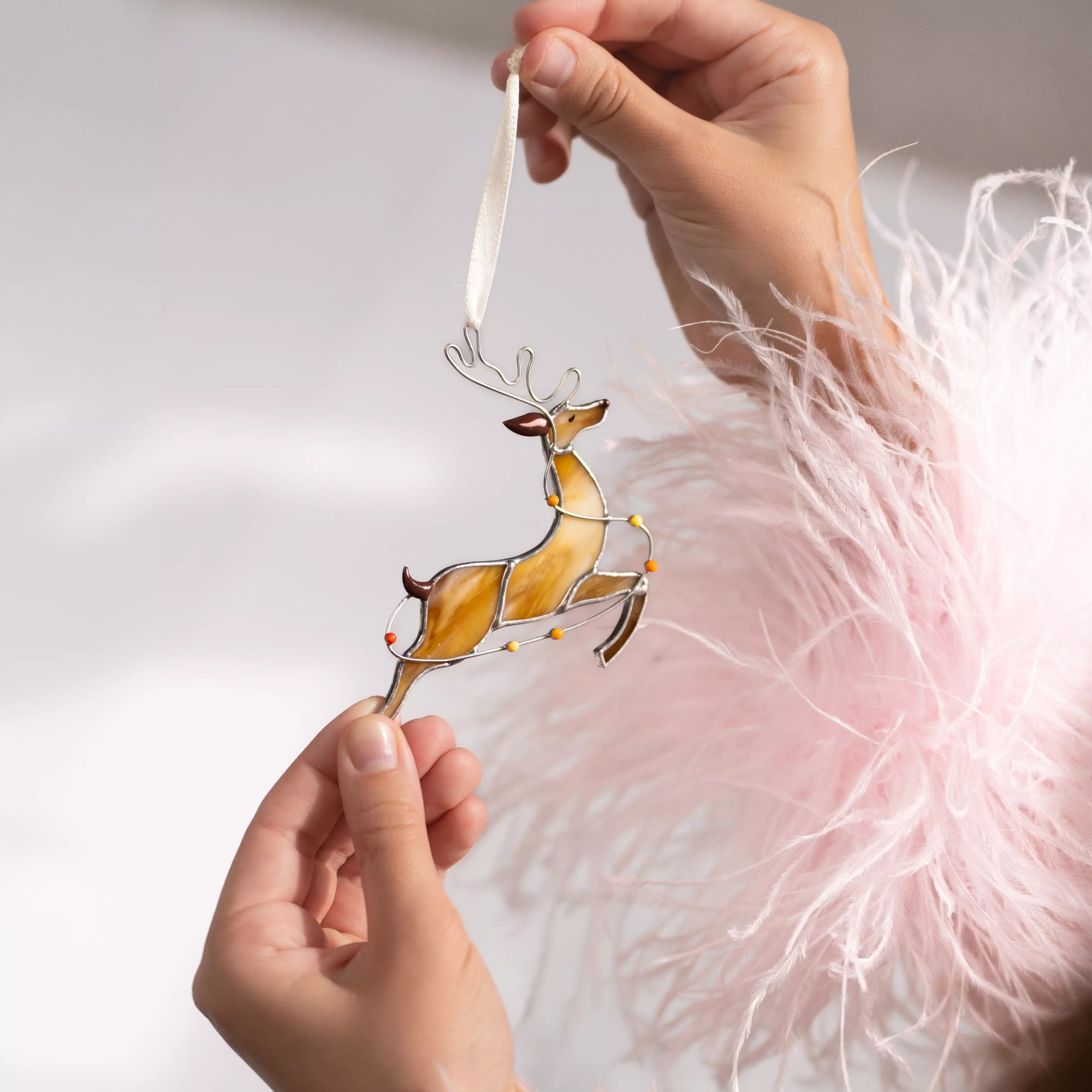 Stained glass reindeer ornament with vibrant lights and holiday cheer