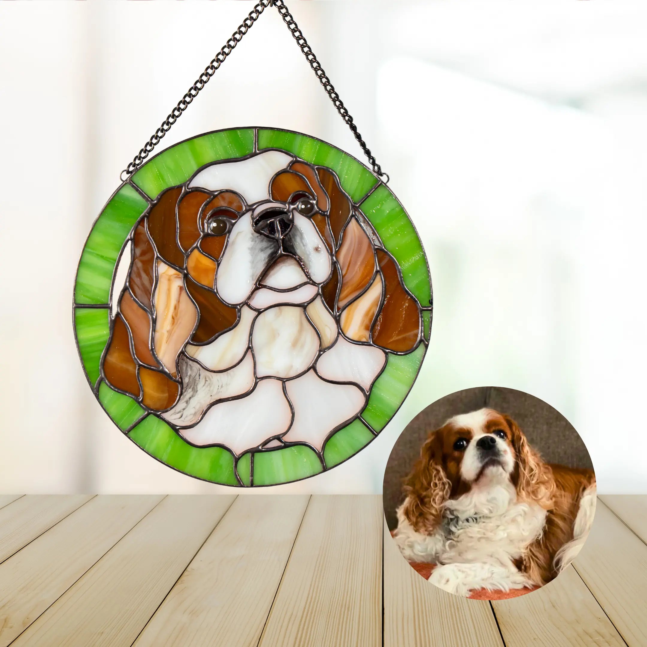 Stained glass round panel dog portrait with a real-life photo of a dog on a wooden surface.
