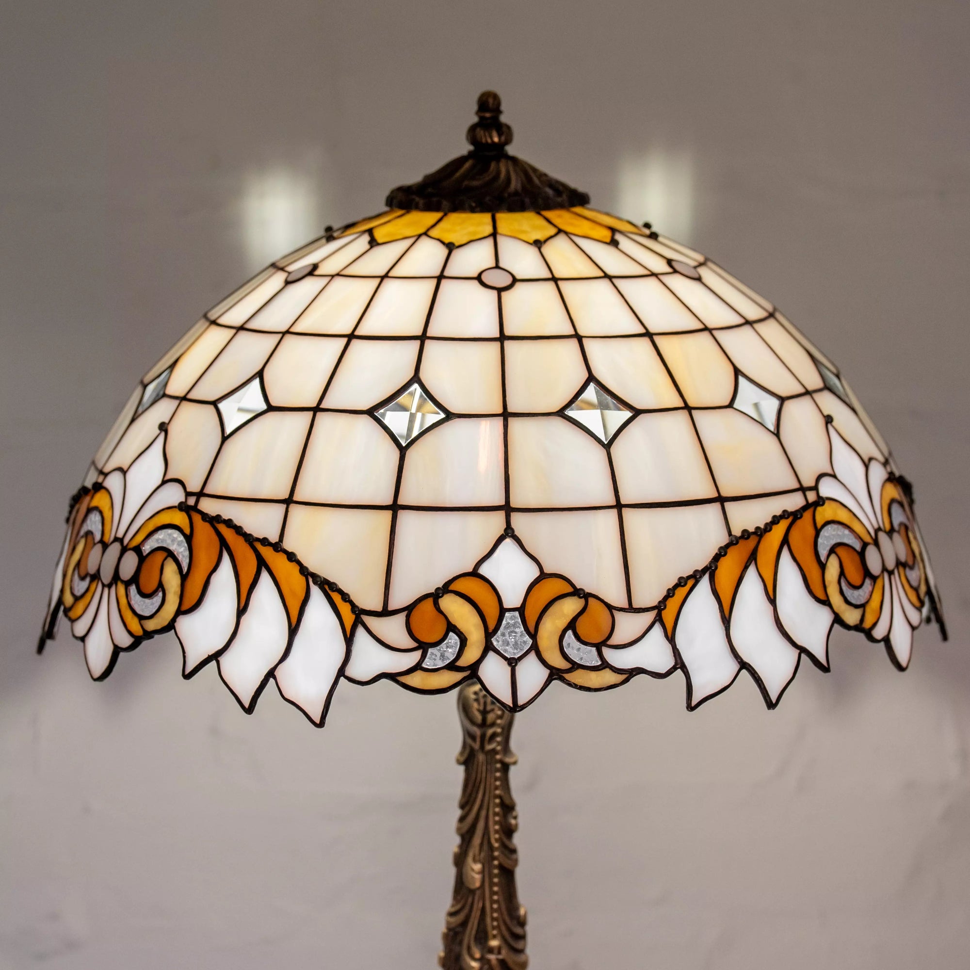 Overhead view of stained glass dome showing ornamental bronze cap and symmetrical glasswork