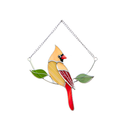 Female cardinal in beige stained glass with green glass leaves.