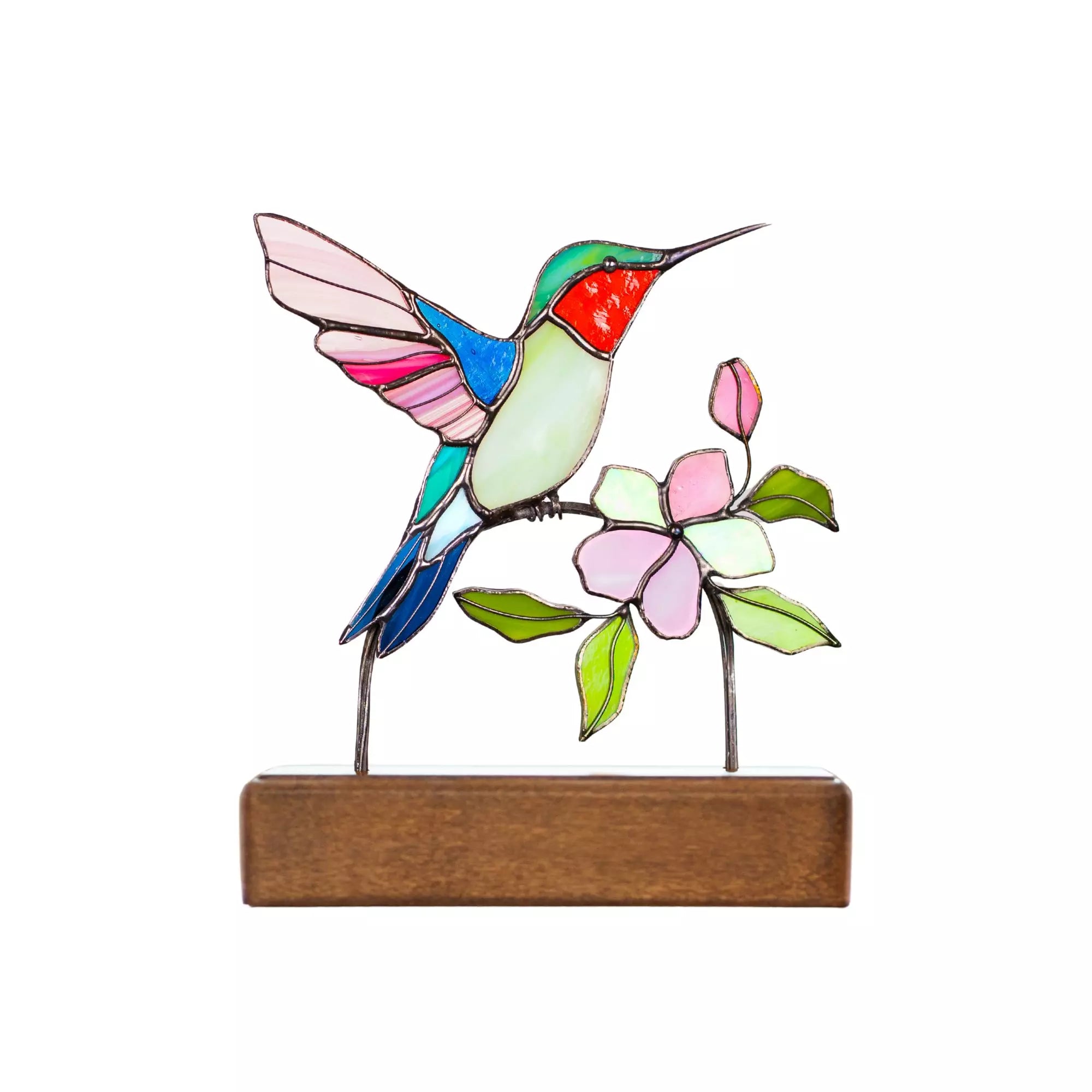 Stained glass hummingbird and flowers on a wooden base against a white background