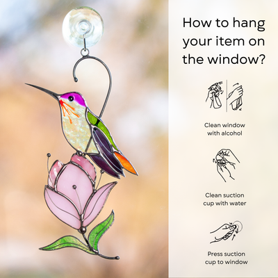 Colorful hummingbird and pink magnolia suncatcher hanging on a window using a suction cup: clean window and suction cup, press a cup to the surface.