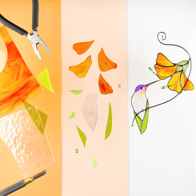 Stages of creating a stained glass hummingbird with orange hibiscus, surrounded by cut glass and pliers