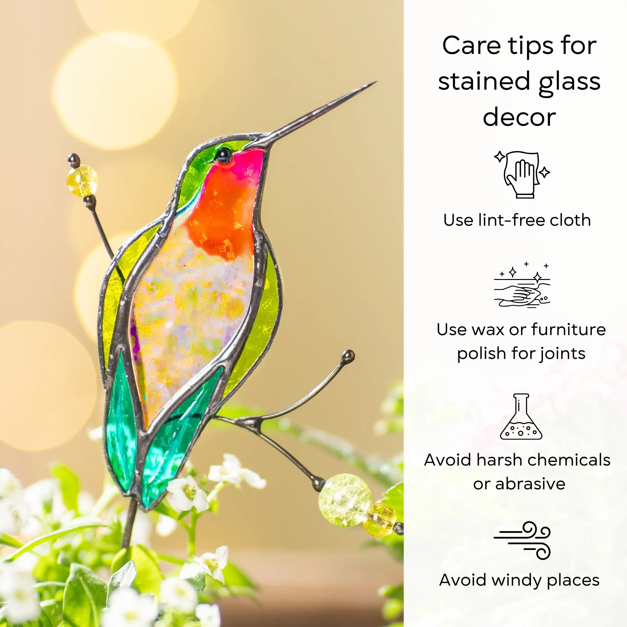 Stained glass hummingbird plant stake with care tips on a blurred natural background: use lint-free cloth, polish joints with car wax or furniture polish, avoid harsh chemicals, and windy places.