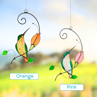 Two stained glass hummingbirds with orange and pink flowers hanging