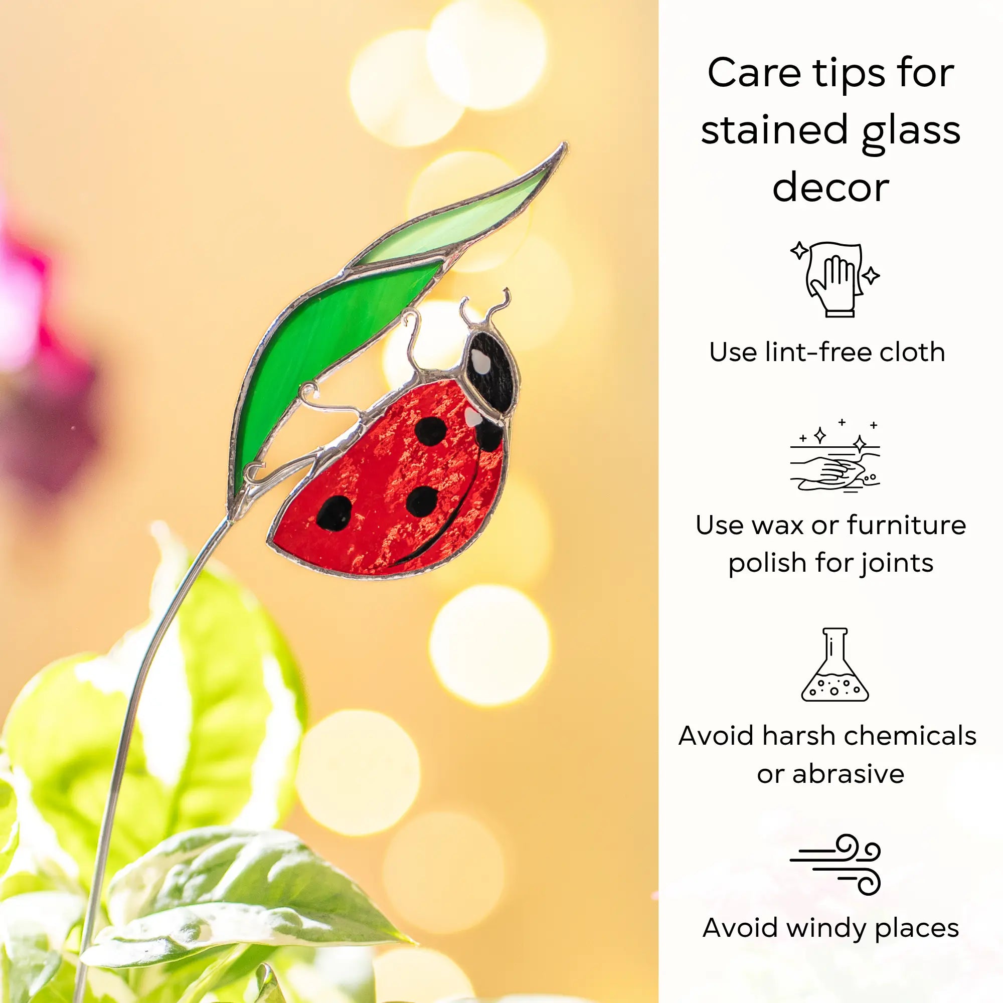Stained glass ladybug plant stake with care tips on a blurred background: use lint-free cloth, polish joints with car wax or furniture polish, avoid harsh chemicals, and windy places.