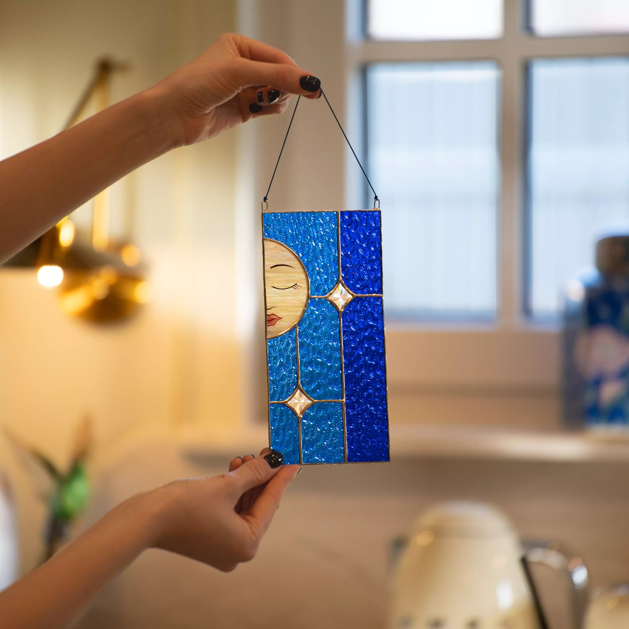 Stained glass moon suncatcher with blue background