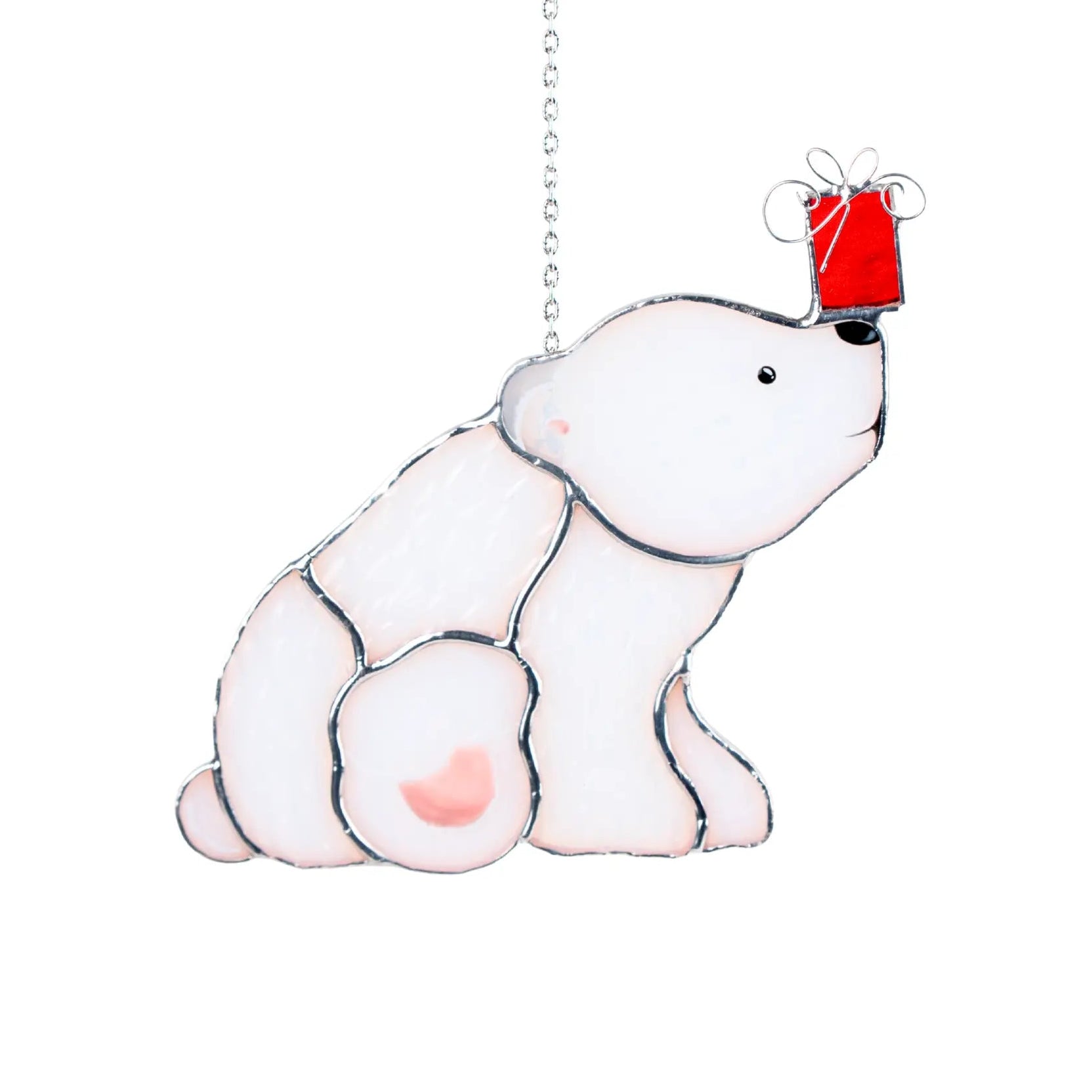 Stained glass suncatcher with a polar bear holding a red gift box on a white background