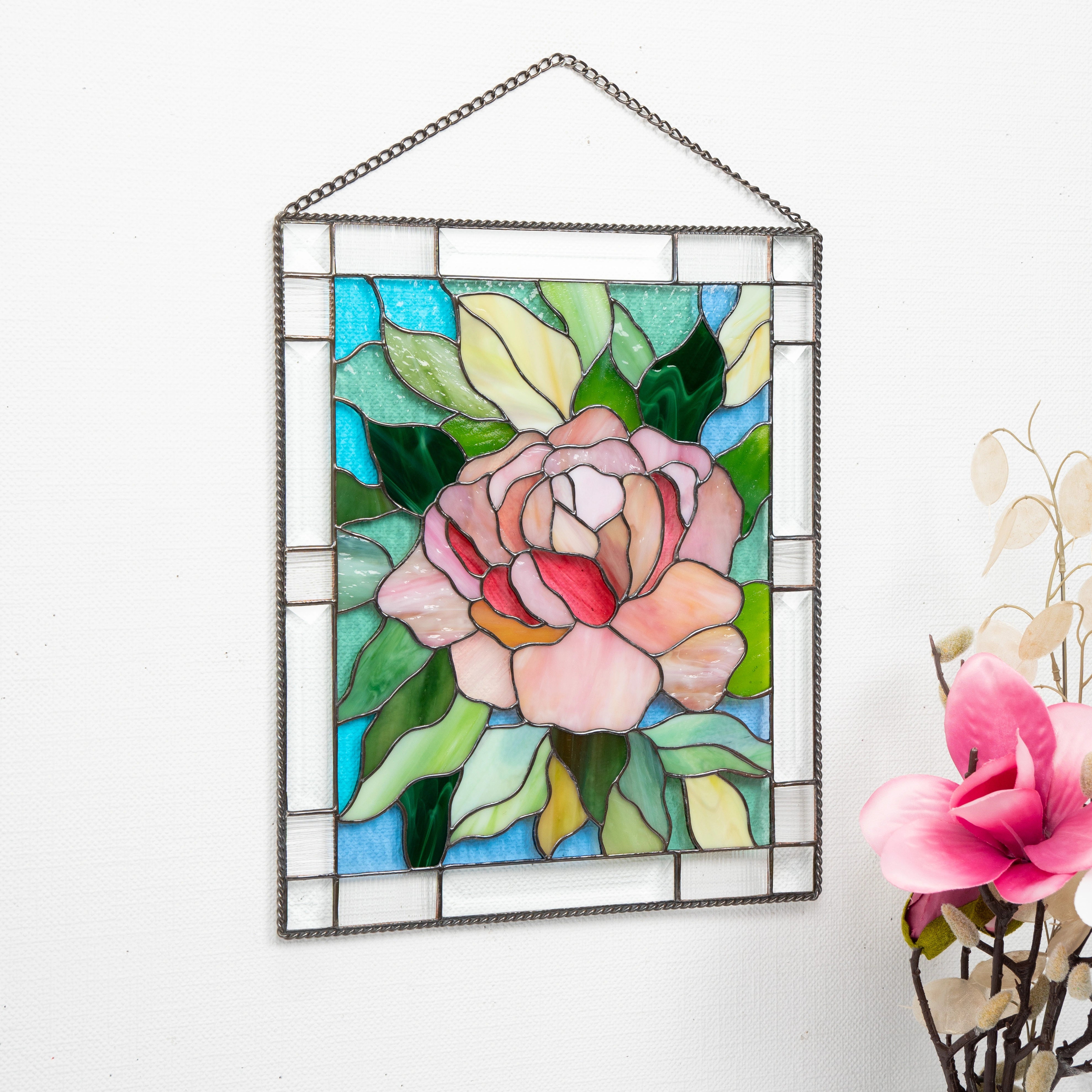 Stained glass panel with floral peony design on a white background