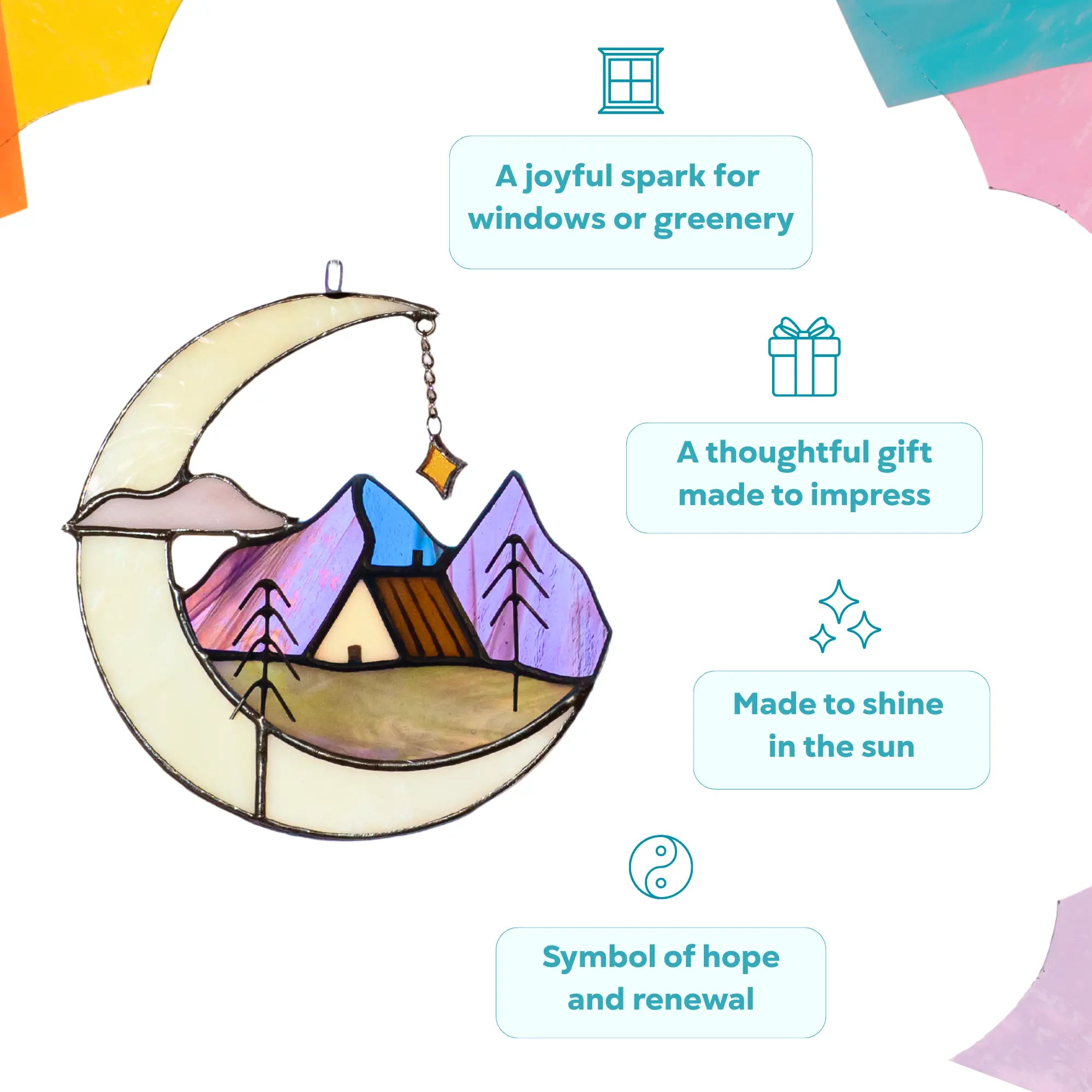 Decorative stained glass piece with a crescent moon, mountain landscape, and house as a symbol of hope and renewal