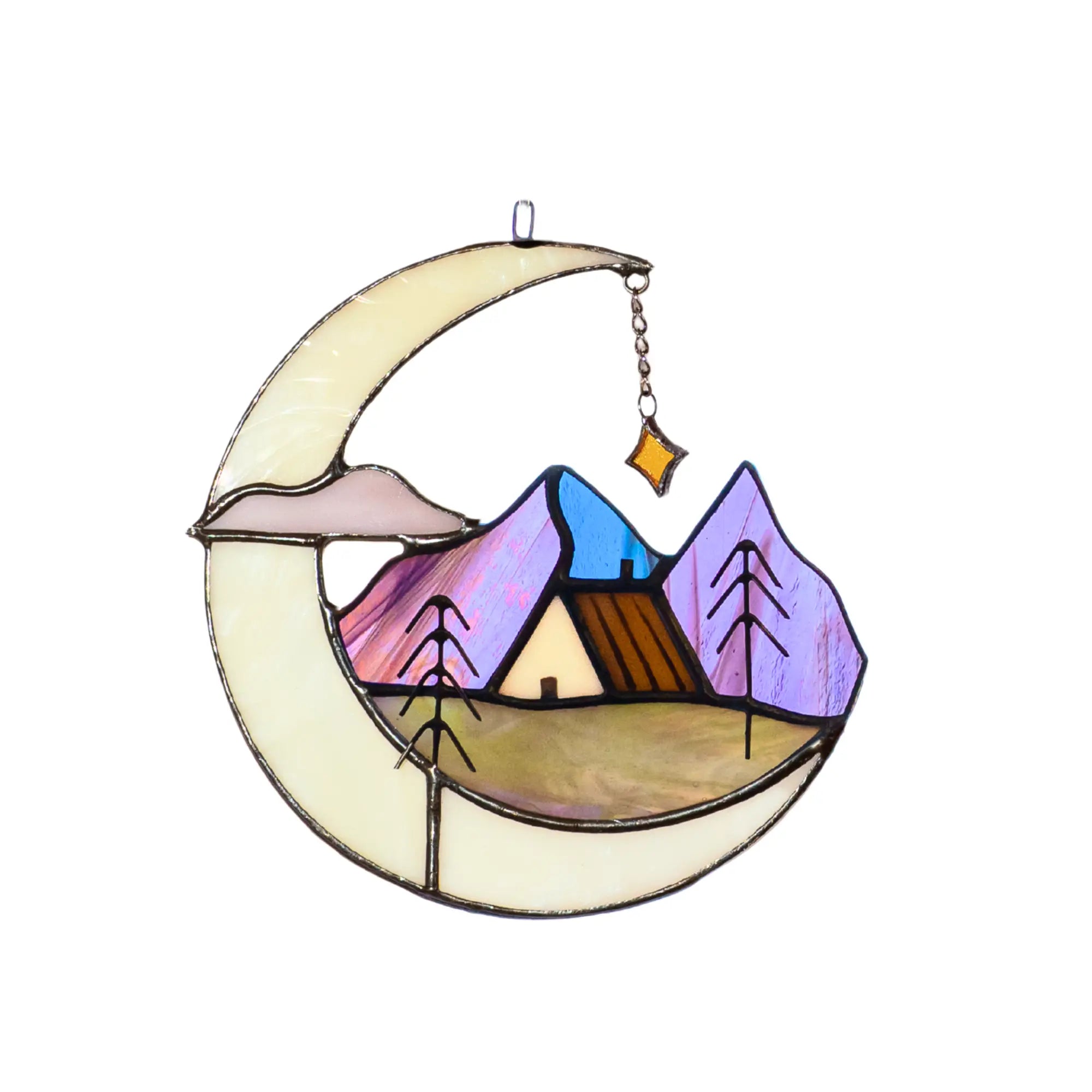 Decorative stained glass piece with a crescent moon, mountain landscape, and house.