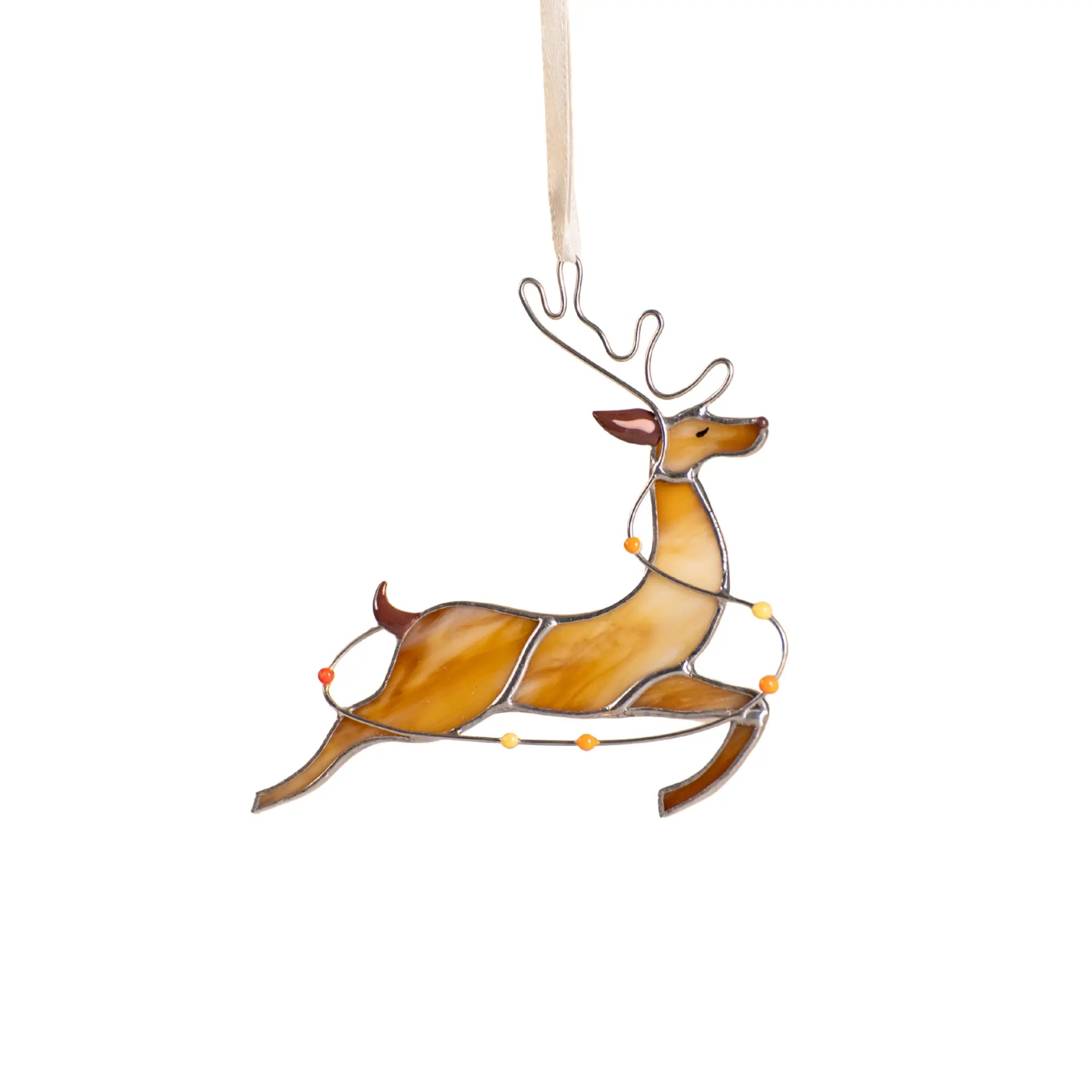 Stained glass reindeer with orange, yellow, and red accents, running with colorful lights