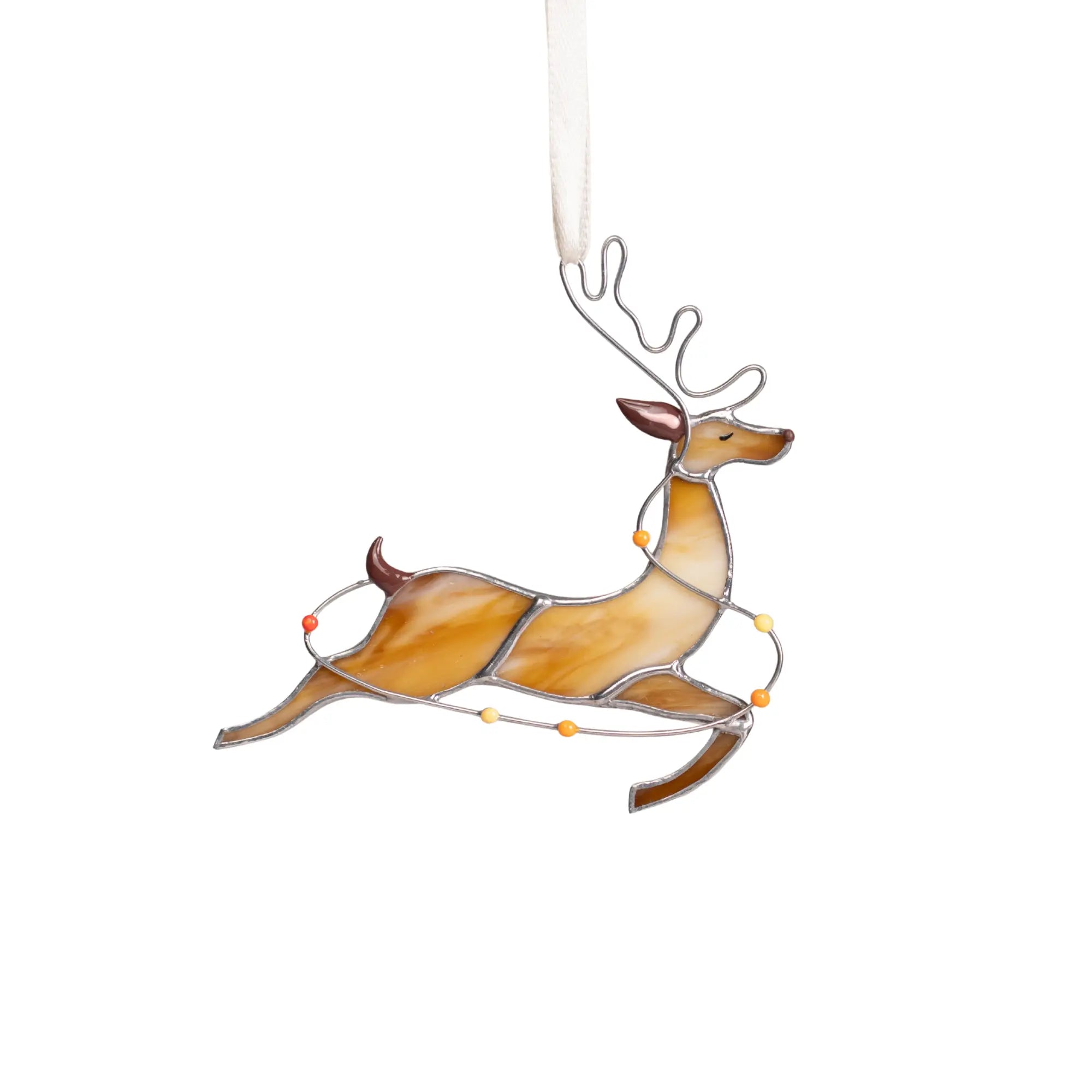 Stained glass reindeer with orange, yellow, and red accents, running with colorful lights