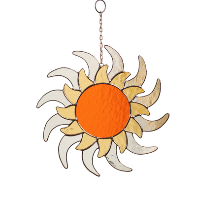Stained glass sun with orange center and double layer of curved yellow and white rays, hanging on chain.
