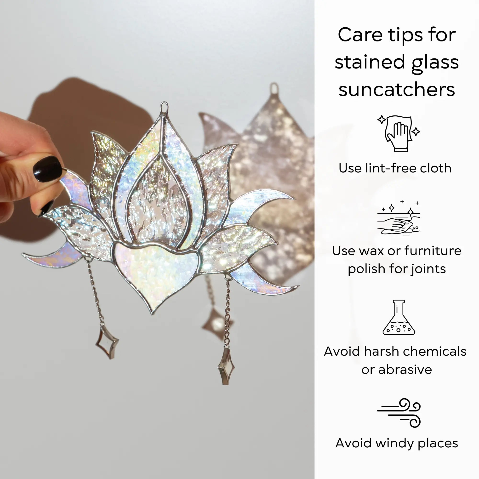 Stained glass lotus flower suncatcher held by a hand with care tips on a gray background: use lint-free cloth, polish joints with car wax or furniture polish, avoid harsh chemicals, and windy places.