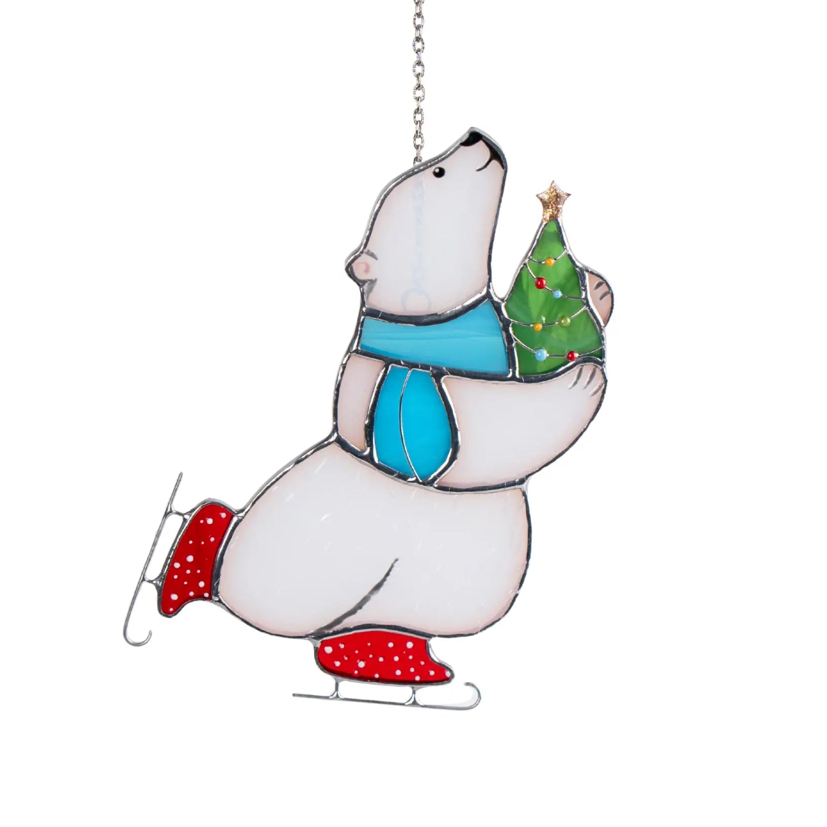 Stained glass suncatcher featuring a polar bear with a Christmas tree on a white background