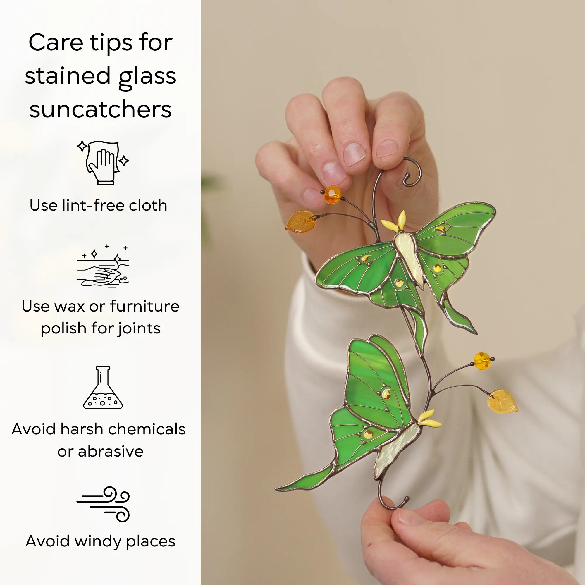 Stained glass suncatcher featuring two luna moth butterflies with care tips: use lint-free cloth, polish joints with car wax or furniture polish, avoid harsh chemicals, and windy places.