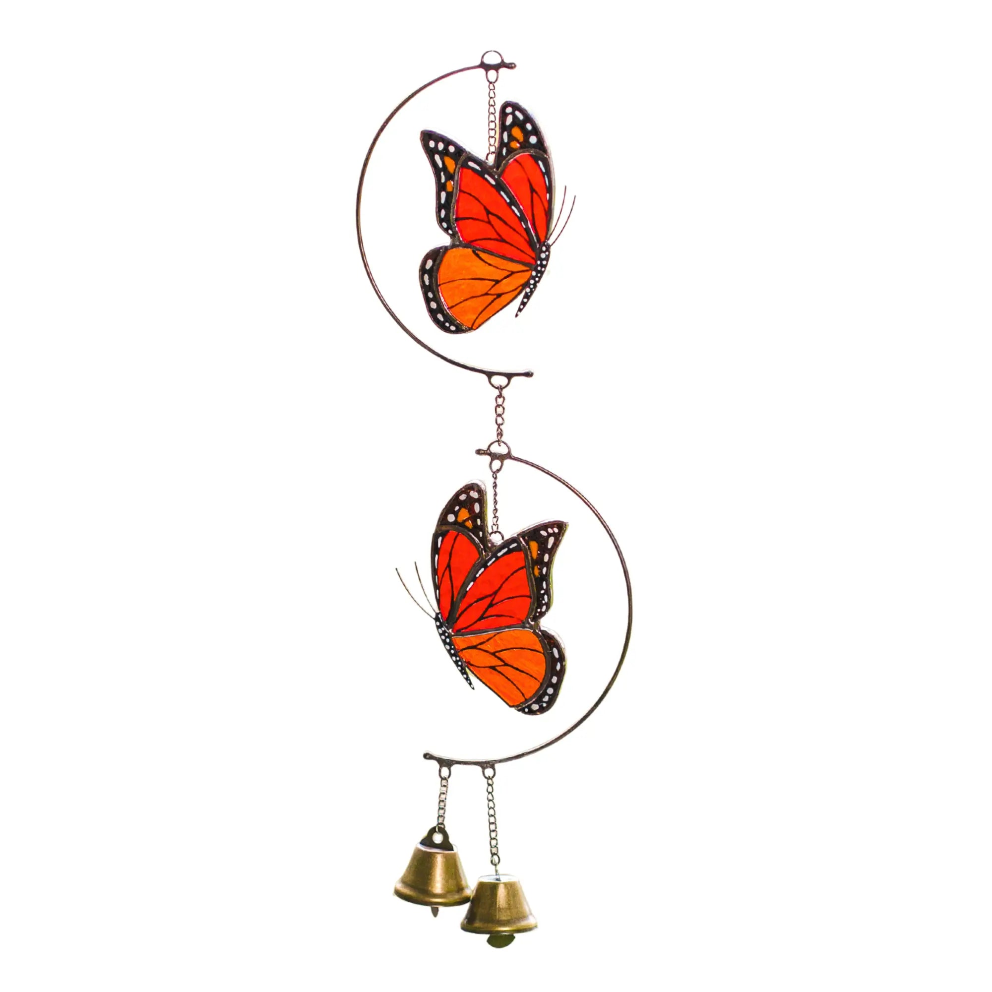 Stained glass wind chime with two orange monarch butterflies and two small brass bells, isolated on a white background.
