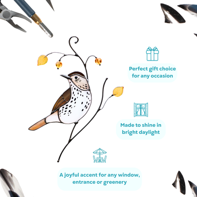 Brown and white stained glass wood thrush with orange beads and glass leaf accents on a white background