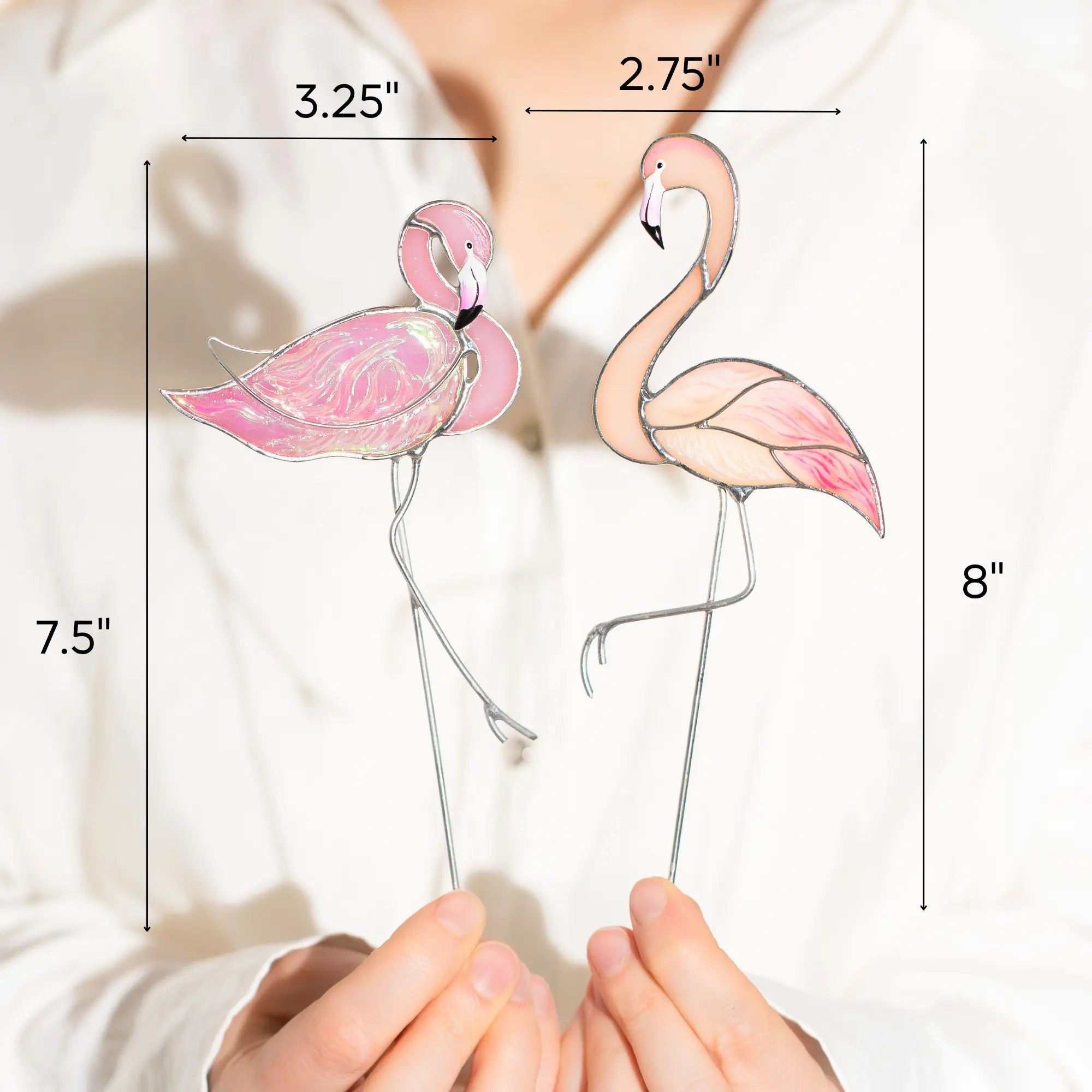 Two pink flamingo stained glass plant stakes with measurements on a white background: 3.25 x 7.5 inches left and 2.75 x 8 inches right