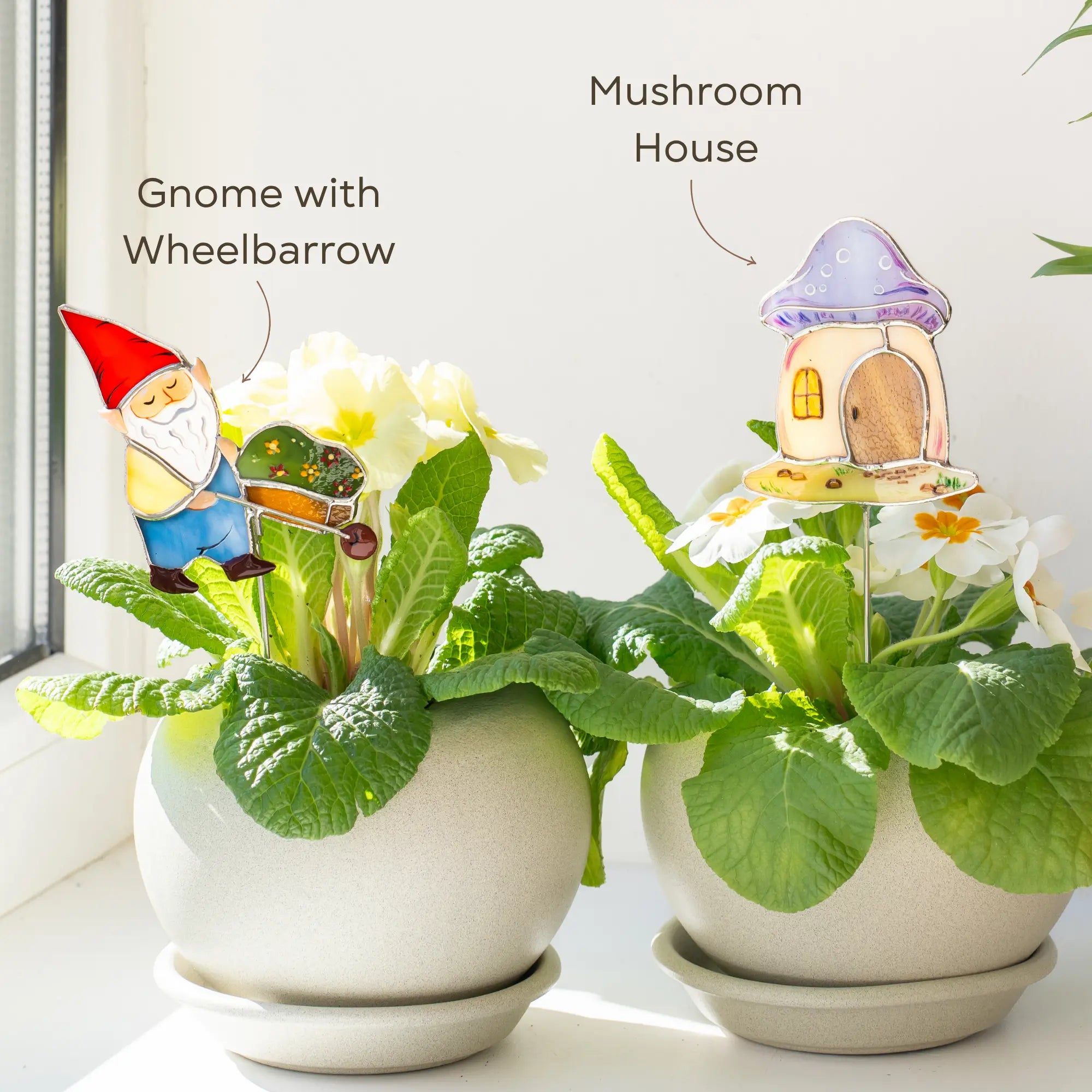 Two stained glass plant plants with a gnome and mushroom house decoration on a light background