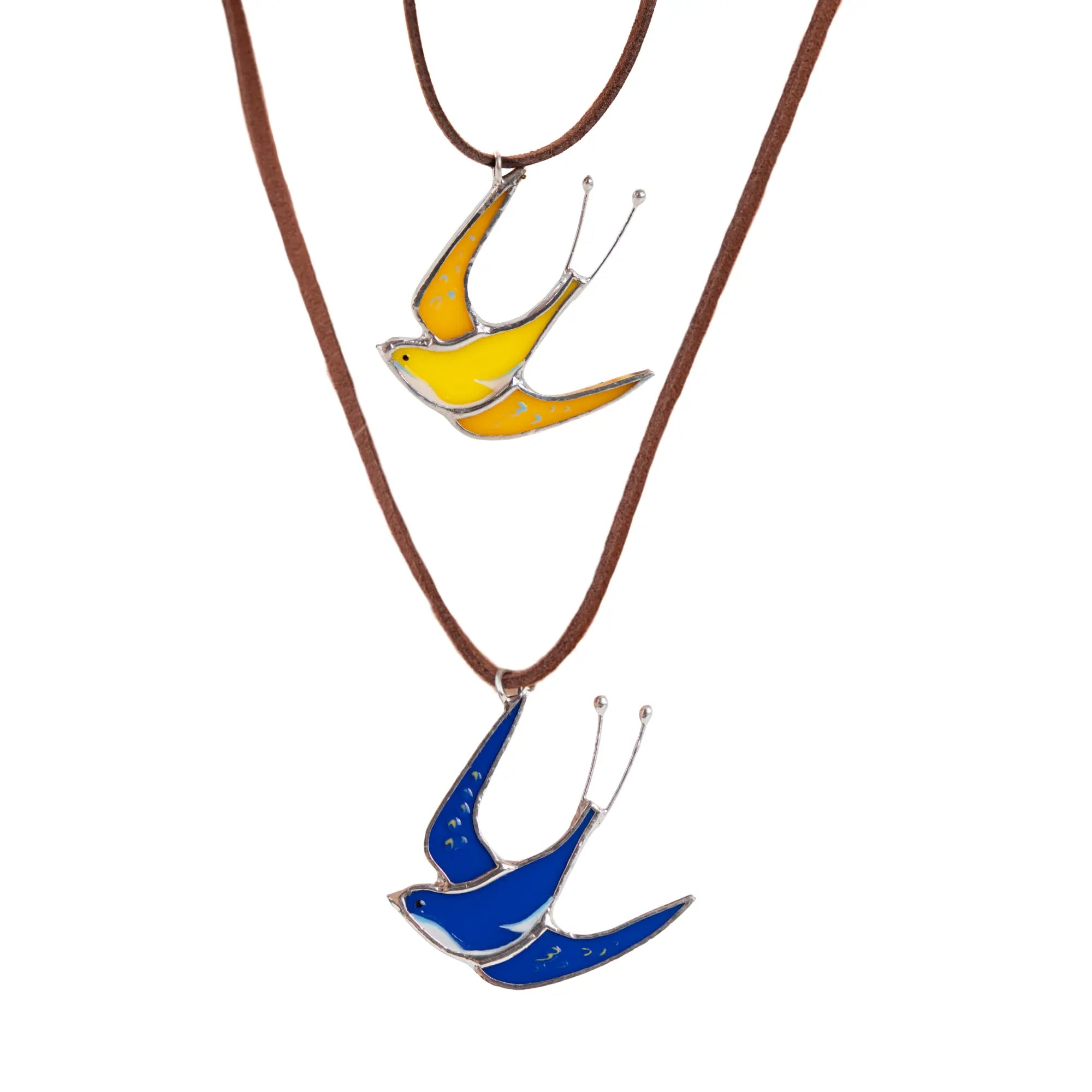 Handmade stained glass swallow necklaces – yellow and blue bird pendants on vegan suede cords.