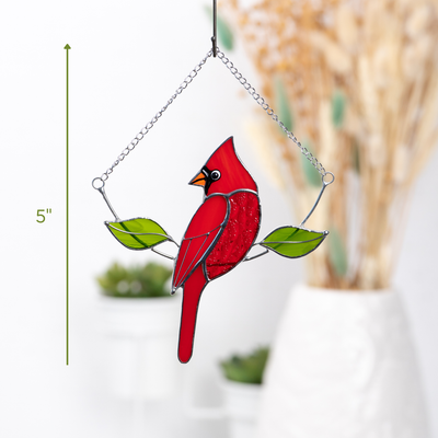 Close-up of red stained glass cardinal suncatcher with measurement at 5 inches, displayed indoors

