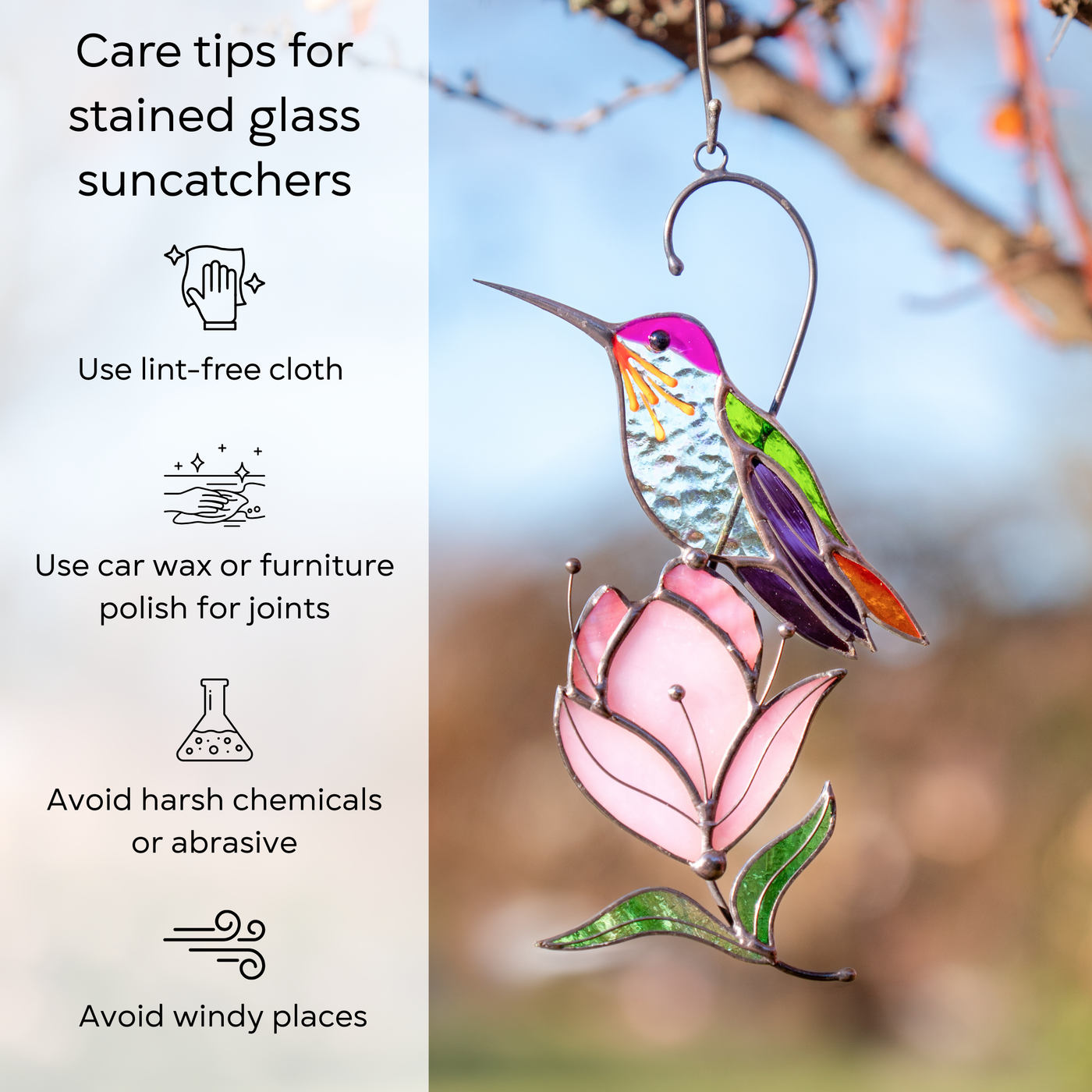 Hummingbird suncatcher with a pink magnolia hanging outdoors, bathed in warm sunlight with instructions beside: use lint-free cloth, use wax polish for joints, no harsh cleaners, avoid wind.