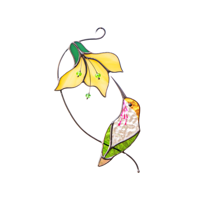 A stained glass suncatcher with a yellow flower and green-white hummingbird