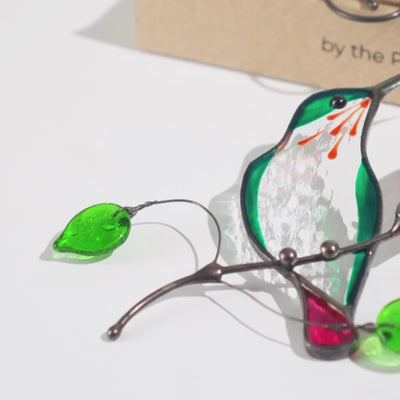 Stained glass green hummingbird suncatcher with green glass leaves