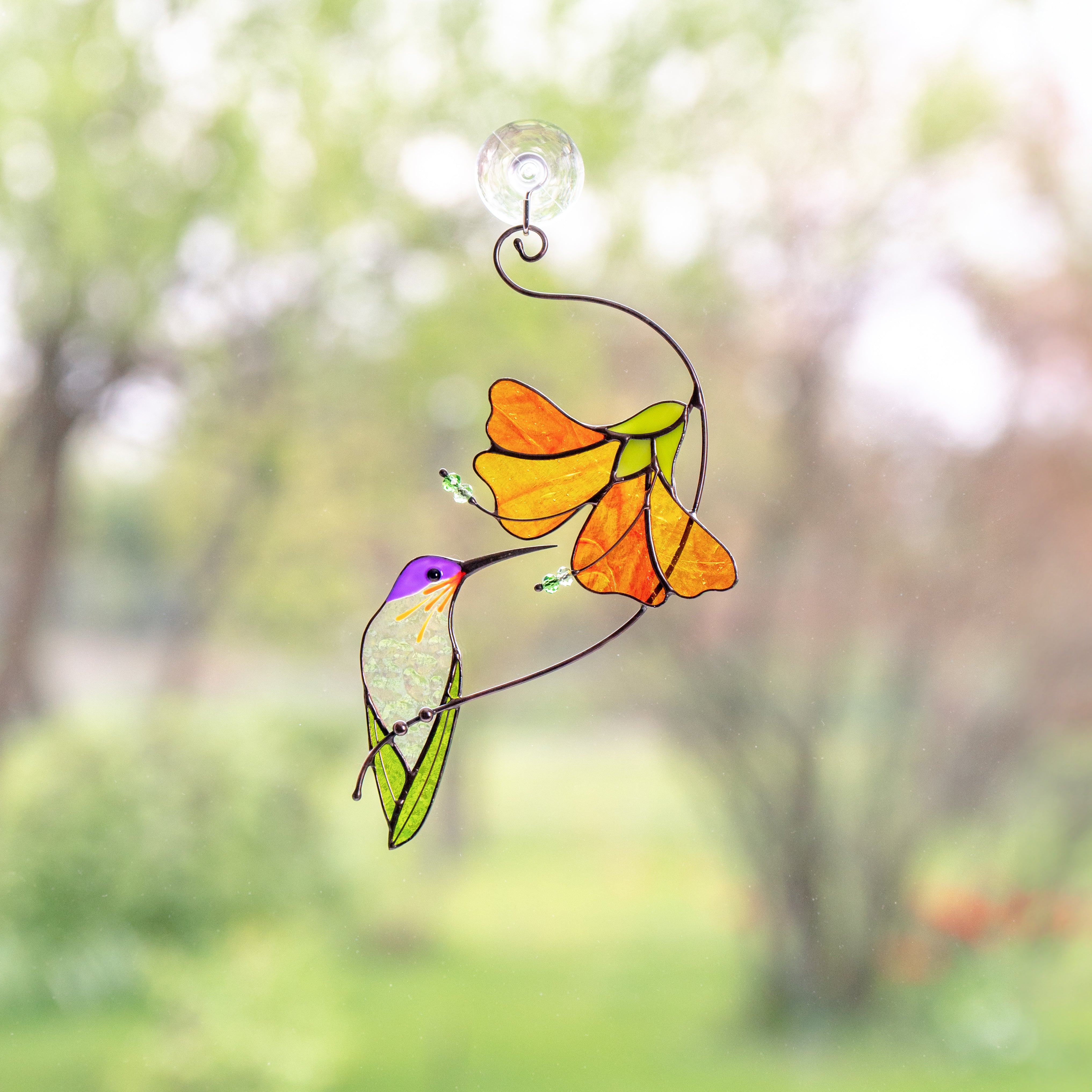 Stained glass hummingbird with hibiscus flower 