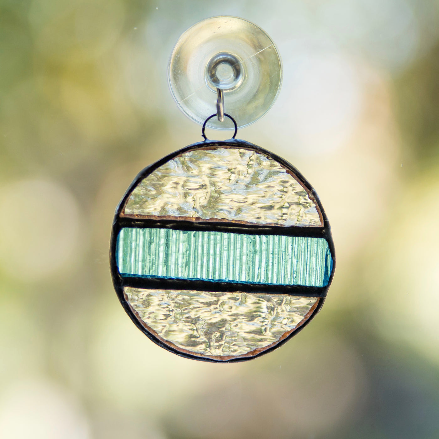 Stained glass clear snowball with the blue insert window hanging 