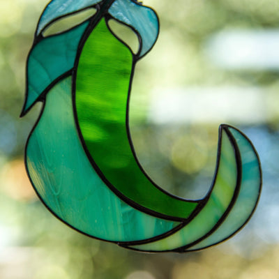 Zoomed stained glass green with its shades bending eight suncatcher