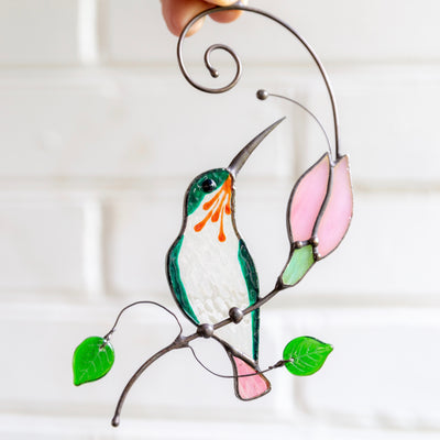 Sitting on the branch with pink flower hummingbird suncatcher of stained glass